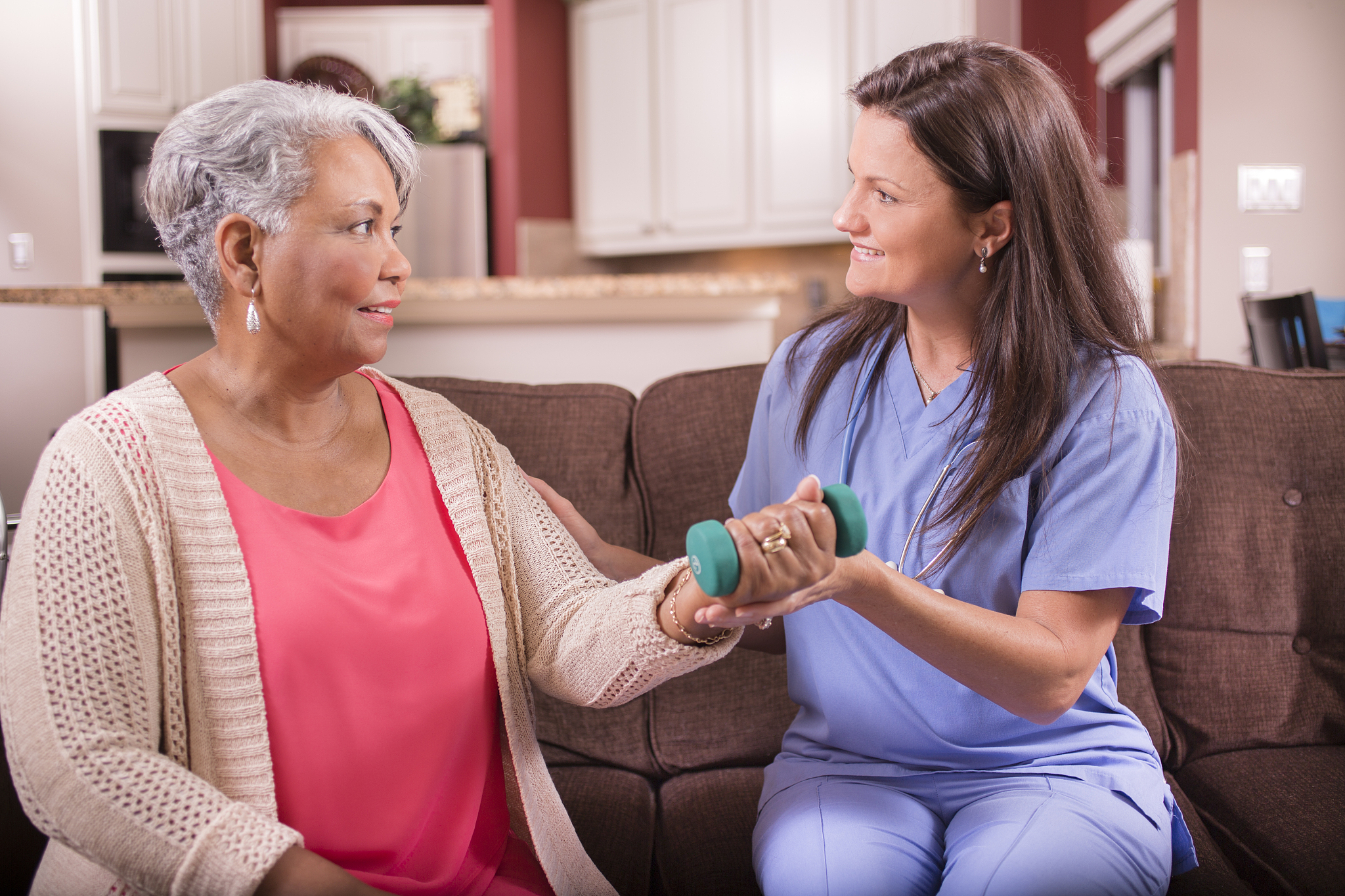 home healthcare nurse, physical therapy with senior adult woman.