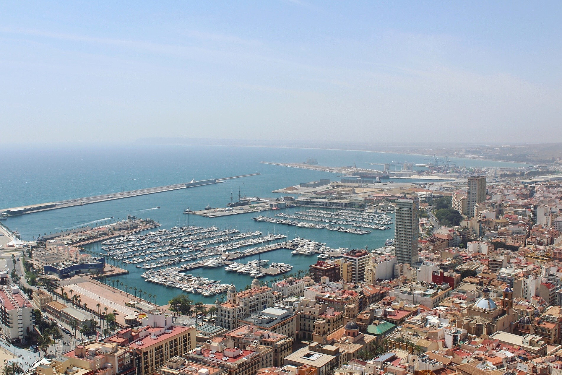high angle view of buildings by sea against sky