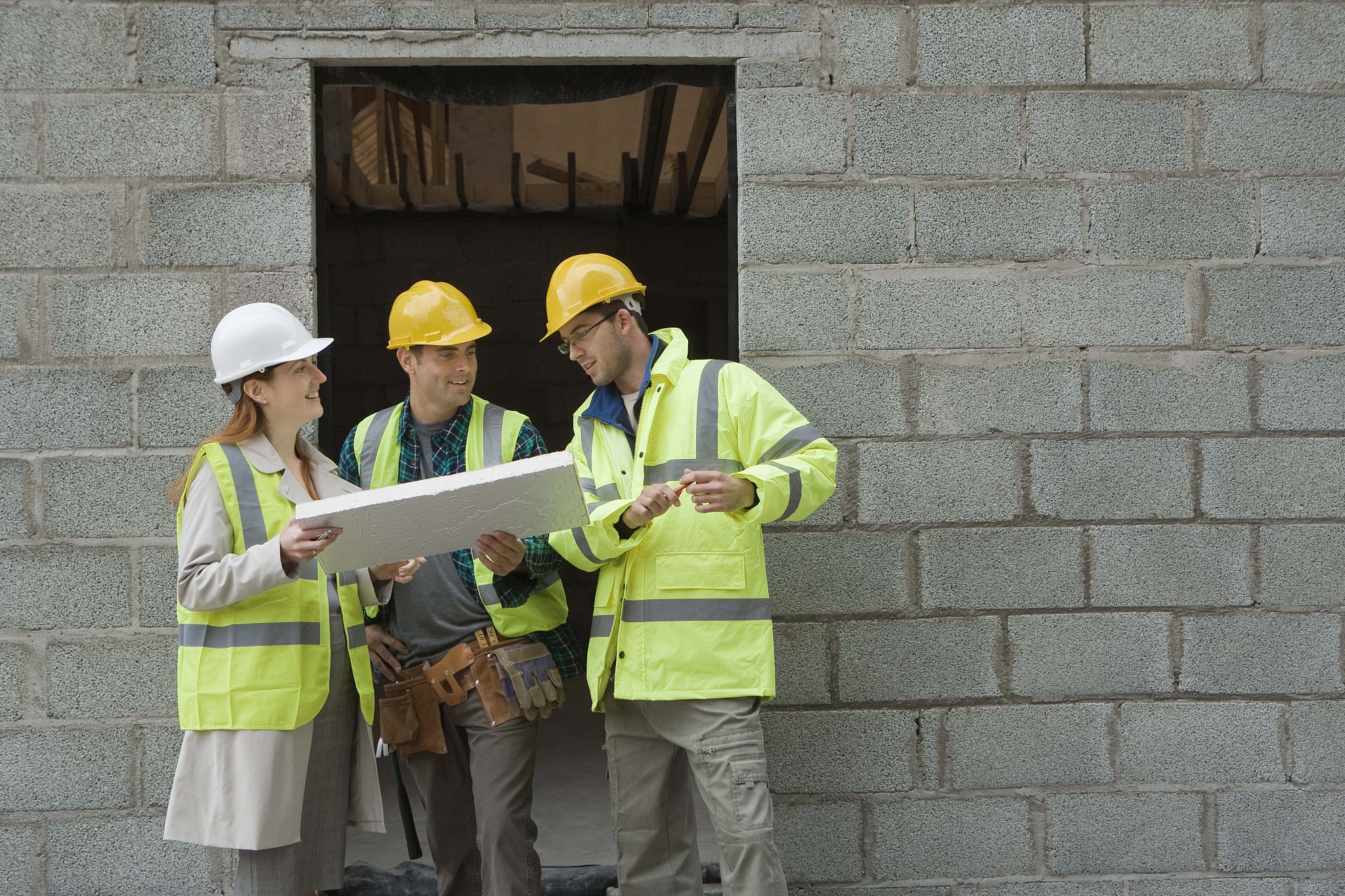 construction workers with building inspector at construction sit