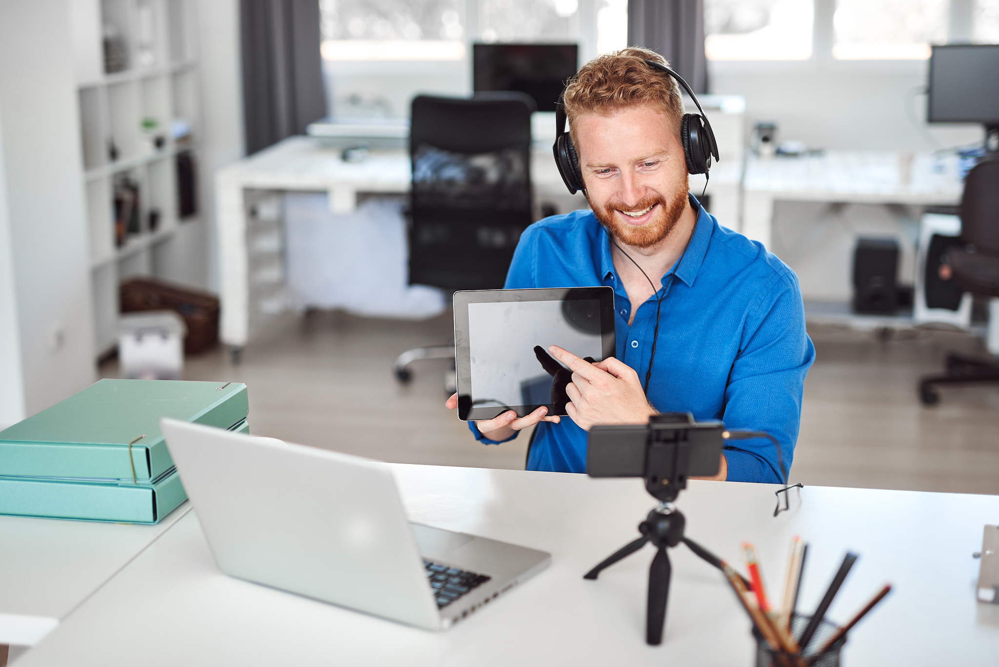 businessman having video call and showing tablet.