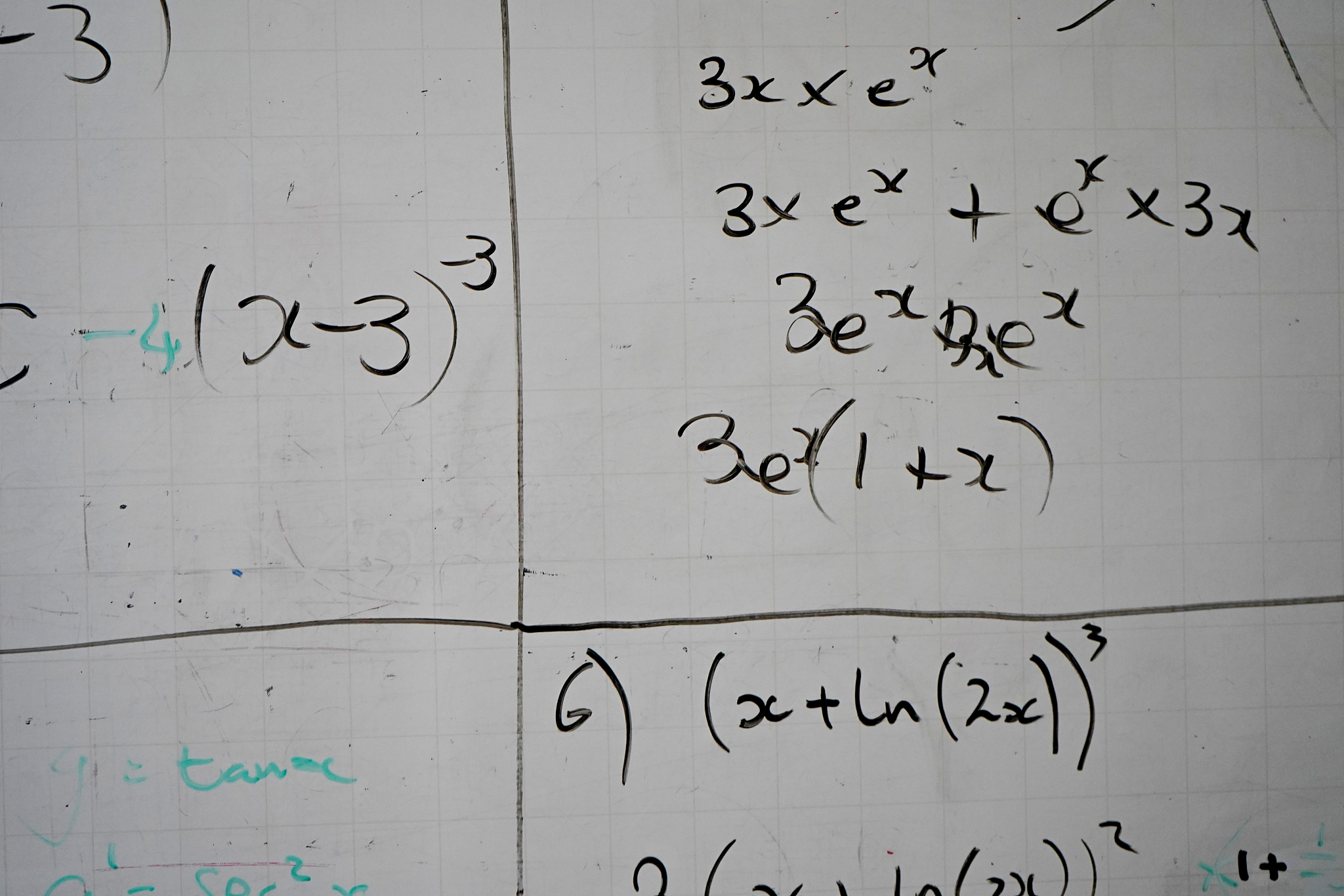 maths and equations on a whiteboard in a classroom
