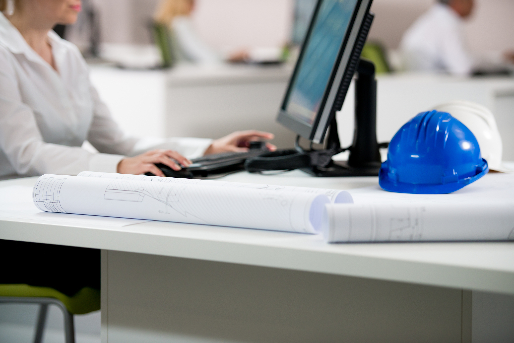 female architect working at computer in office.