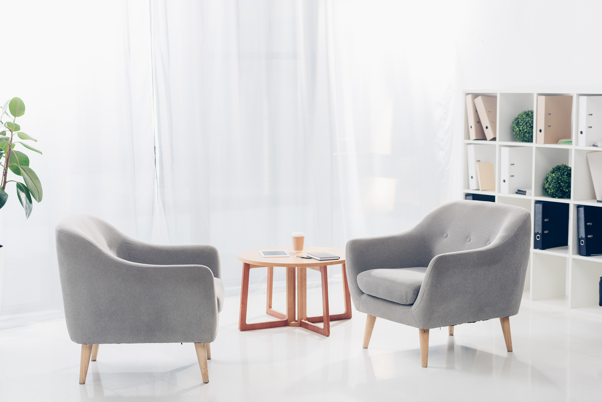 interior of light modern business office with two armchairs, she