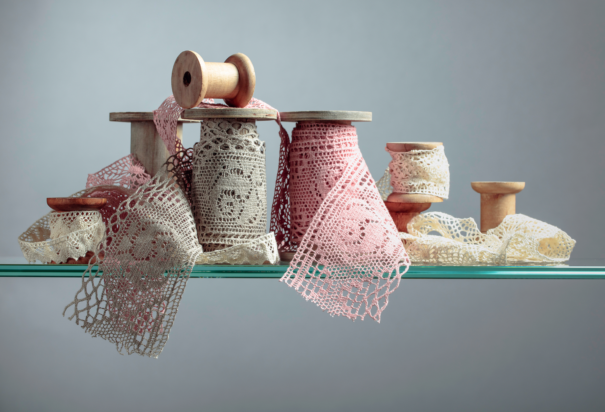 vintage cotton lace trims on wooden spools.