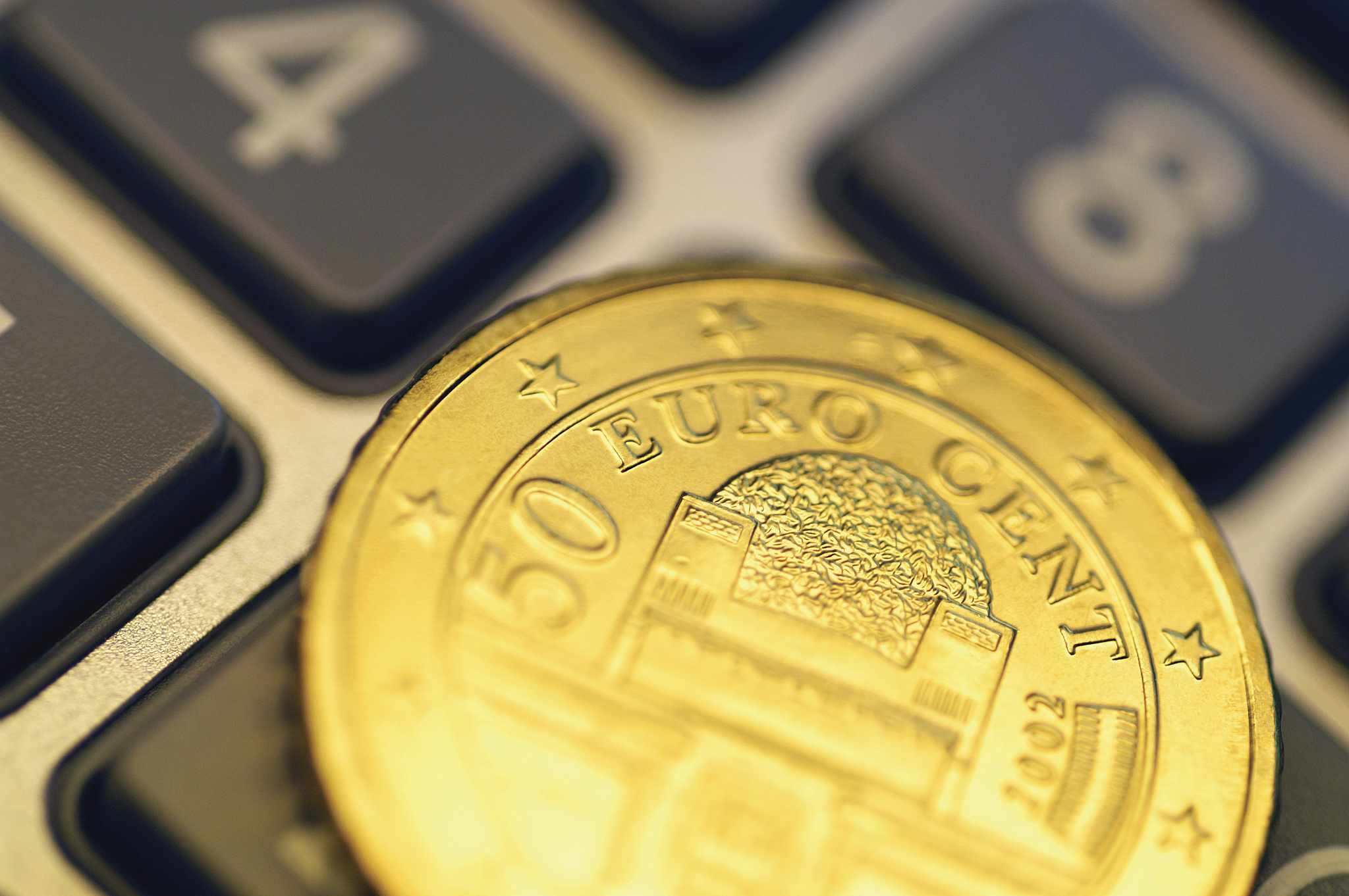 close-up of eurocent coin on calculator