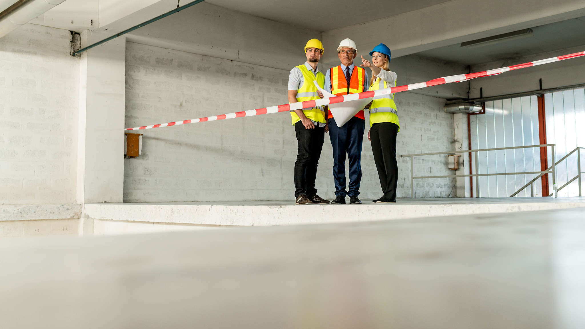 warehouse workers at meeting with architect and foreman