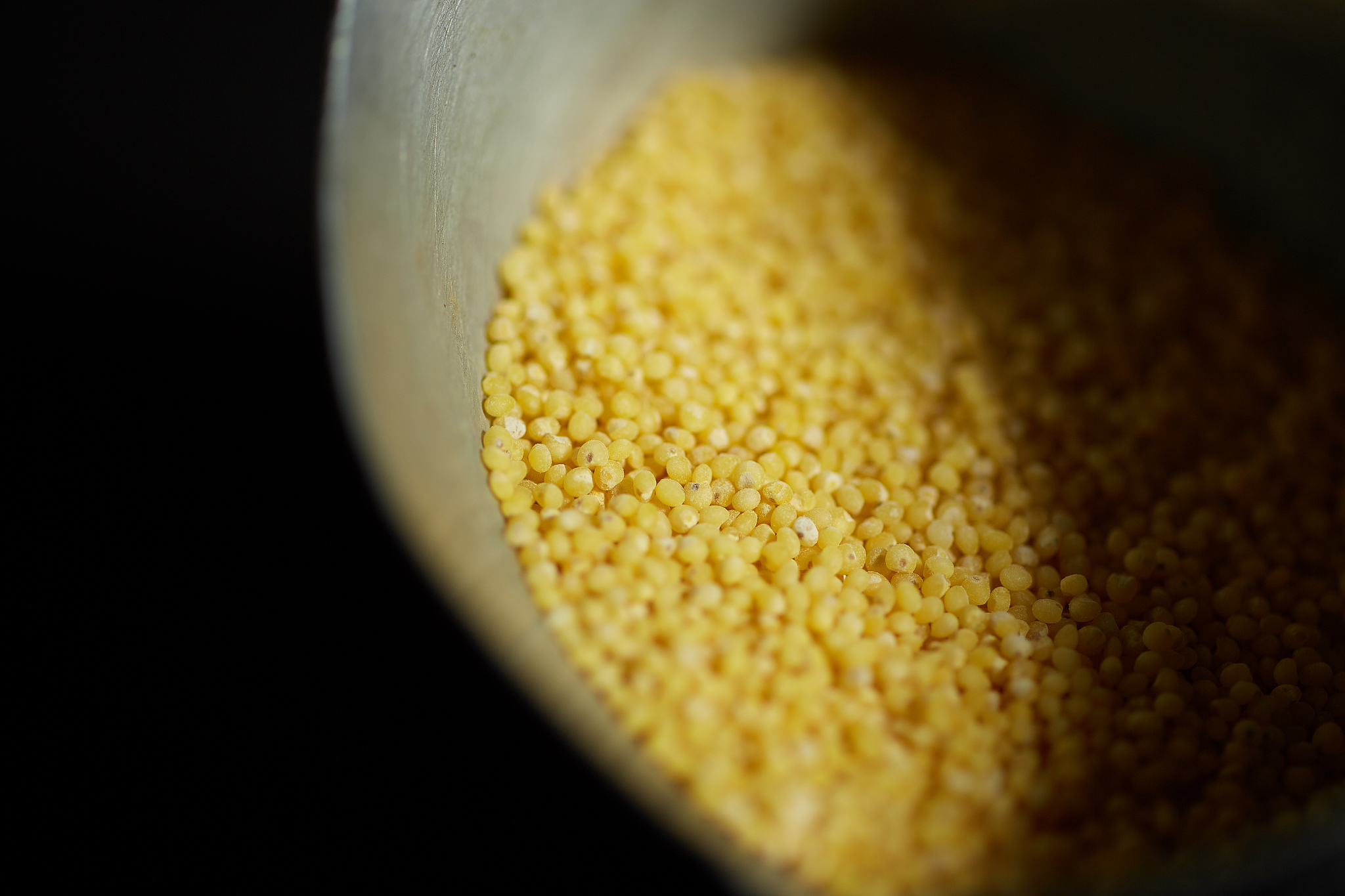 close-up of yellow food in container at darkroom