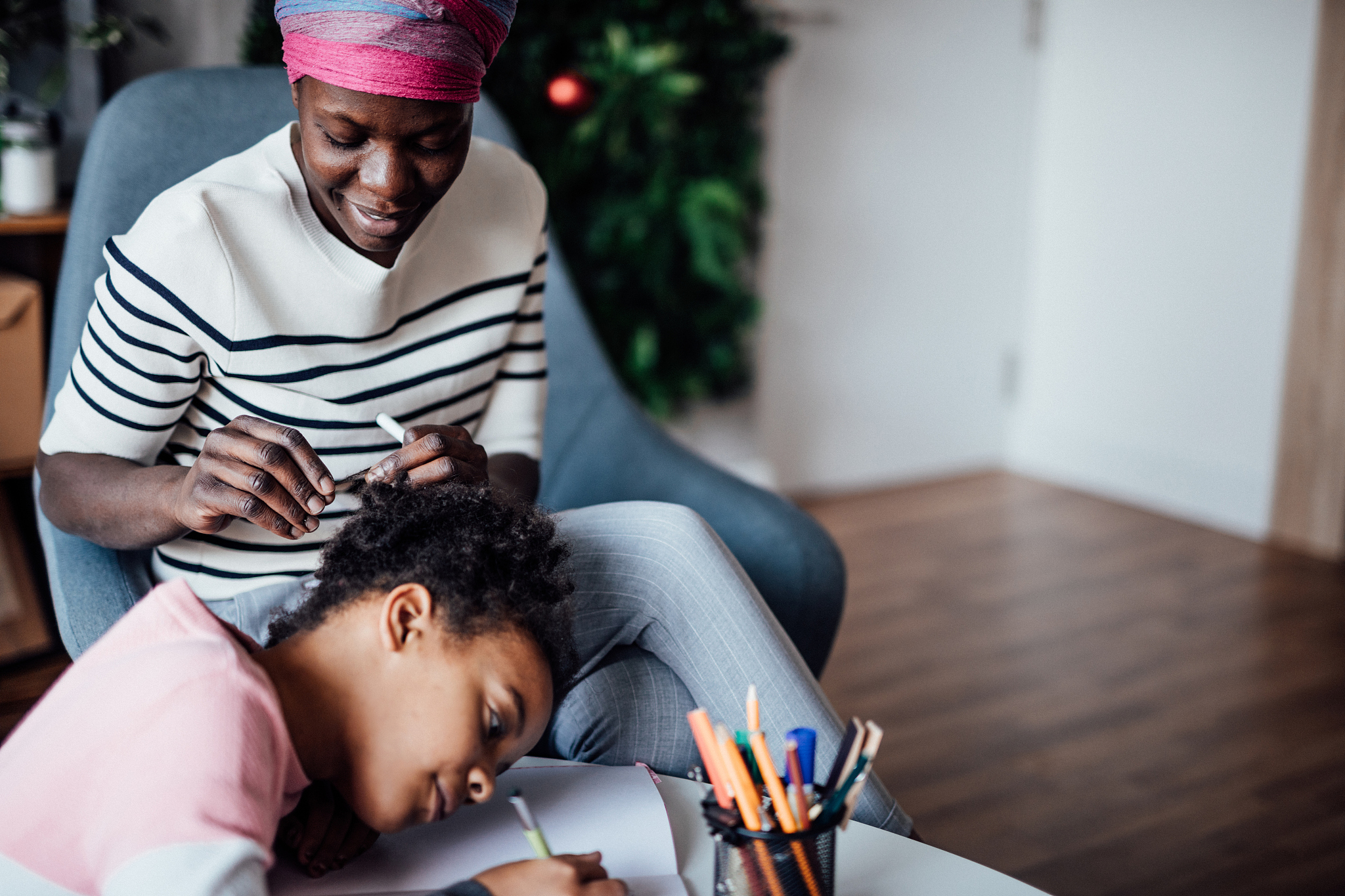 mother helps daughter with homework