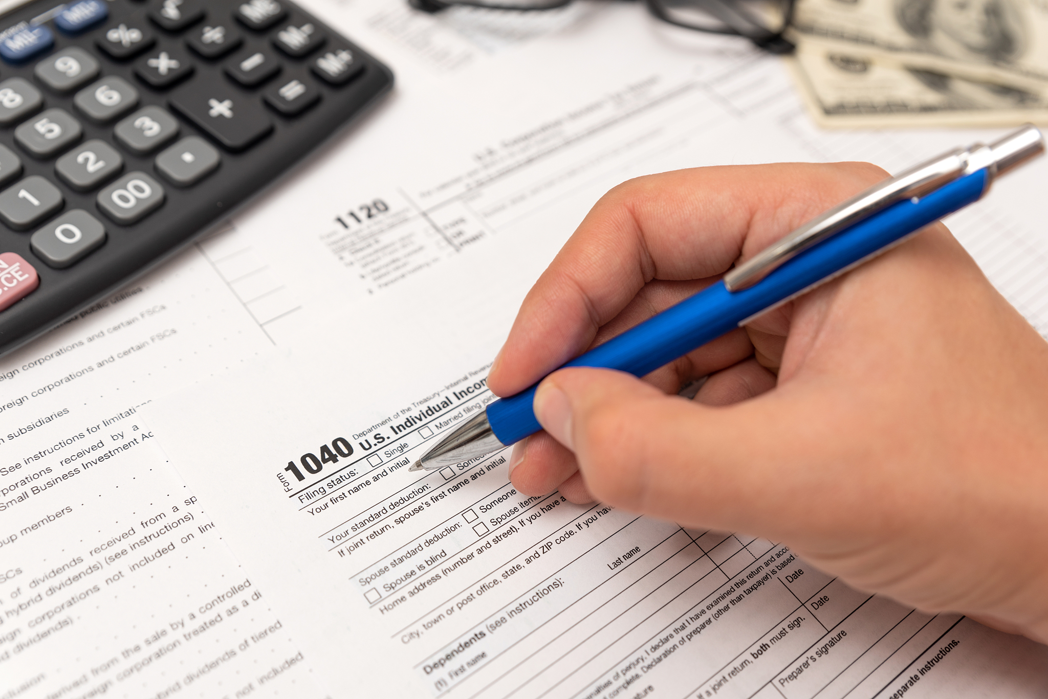 man filling us tax form in office