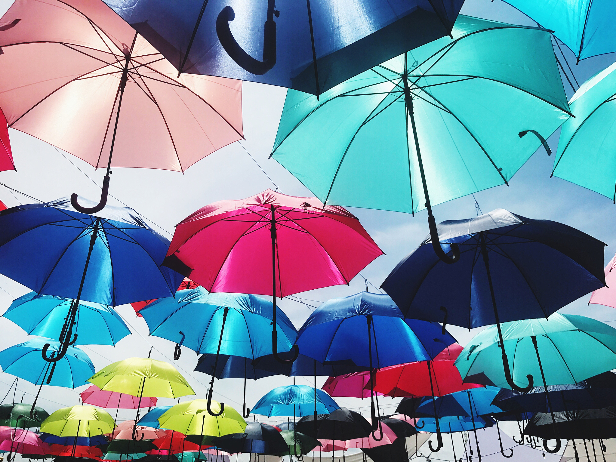 low angle view of umbrellas against sky in market