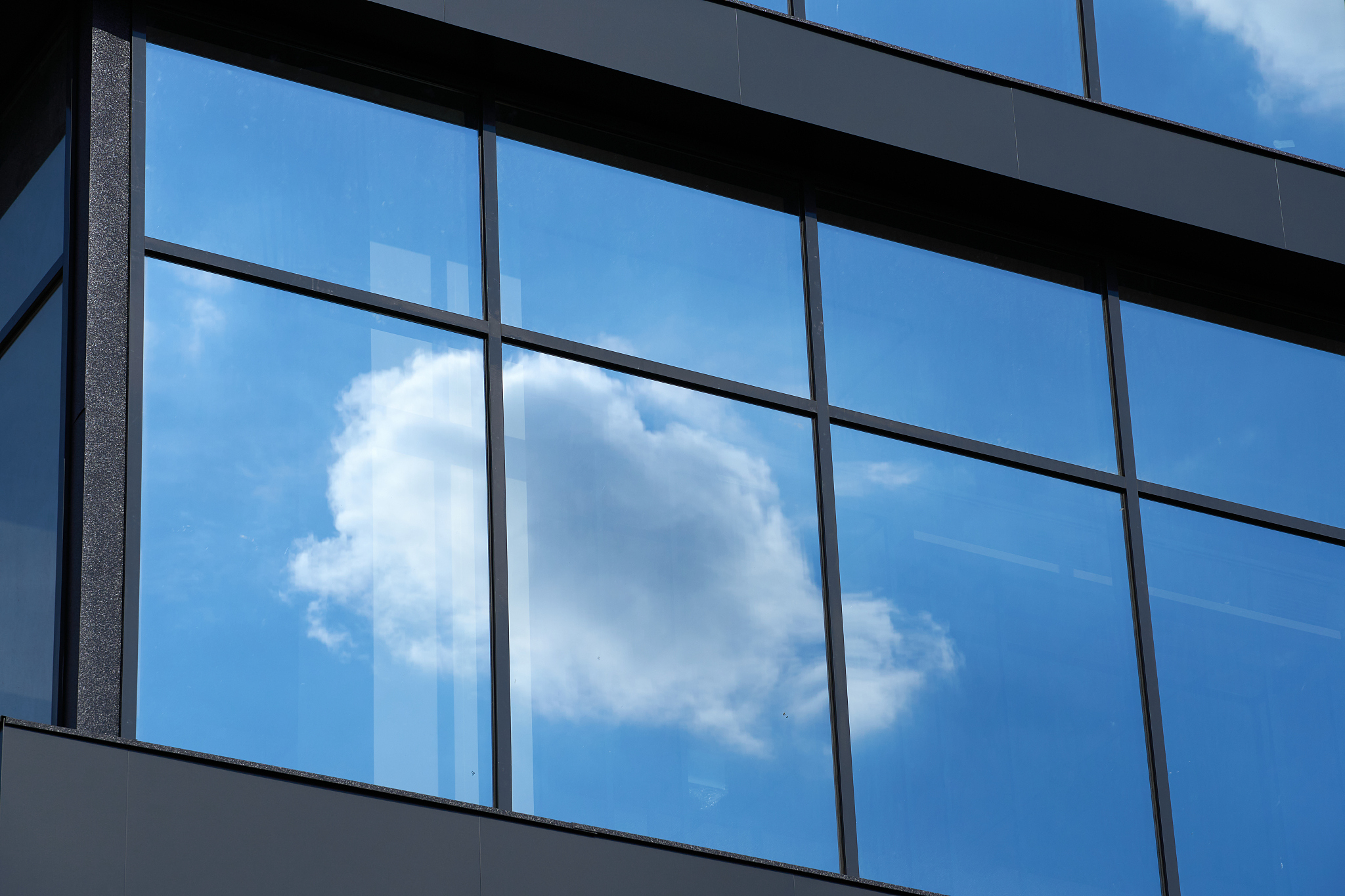 facade of a modern building on a bright sunny day, blue sky and 