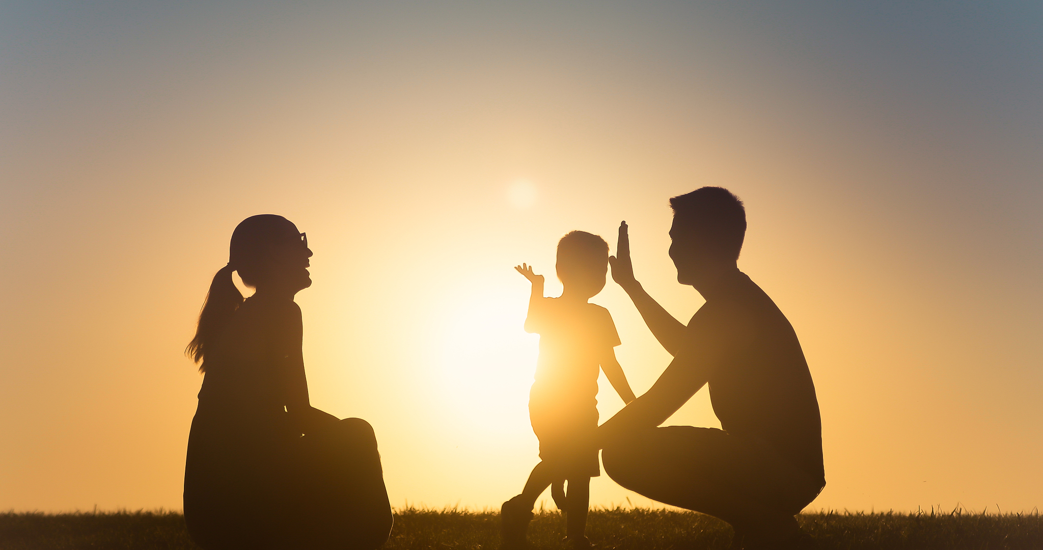 father giving high five to his son.