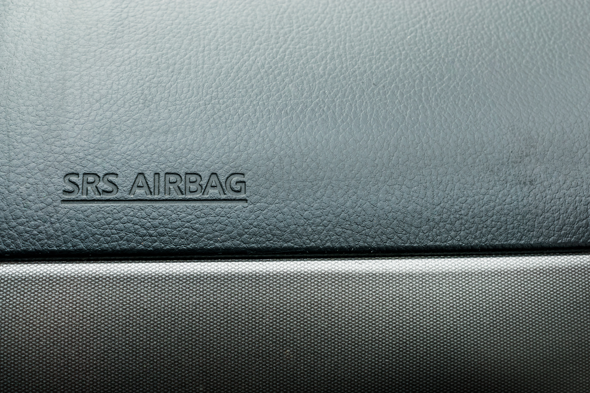 the inscription 'srs airbag' on dashboard inside the car. safety