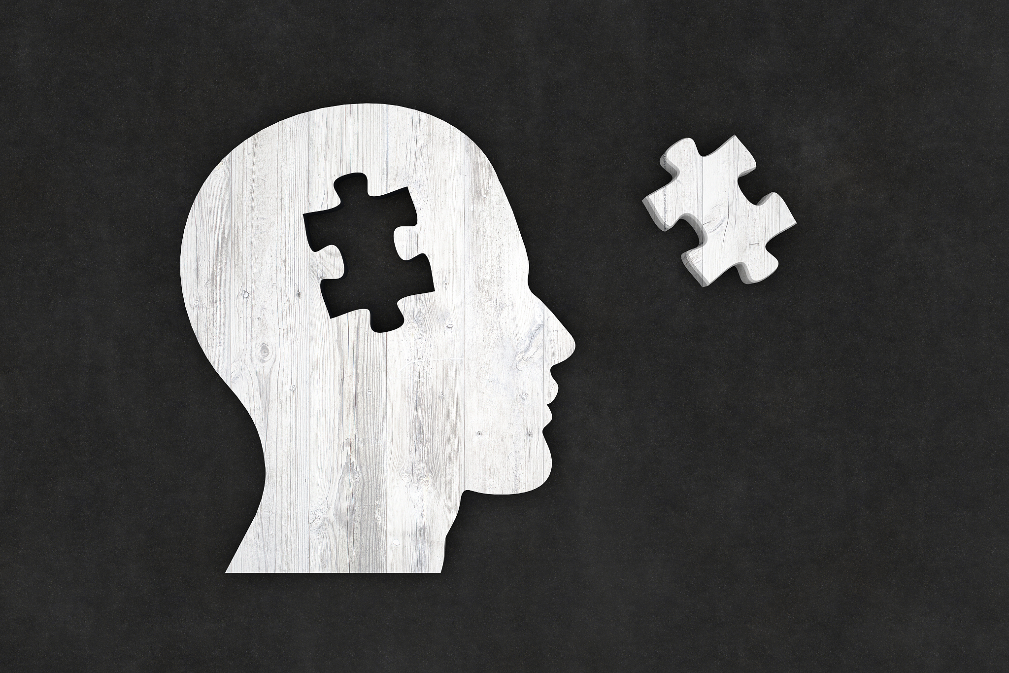 head silhouette with jigsaw puzzle pieces