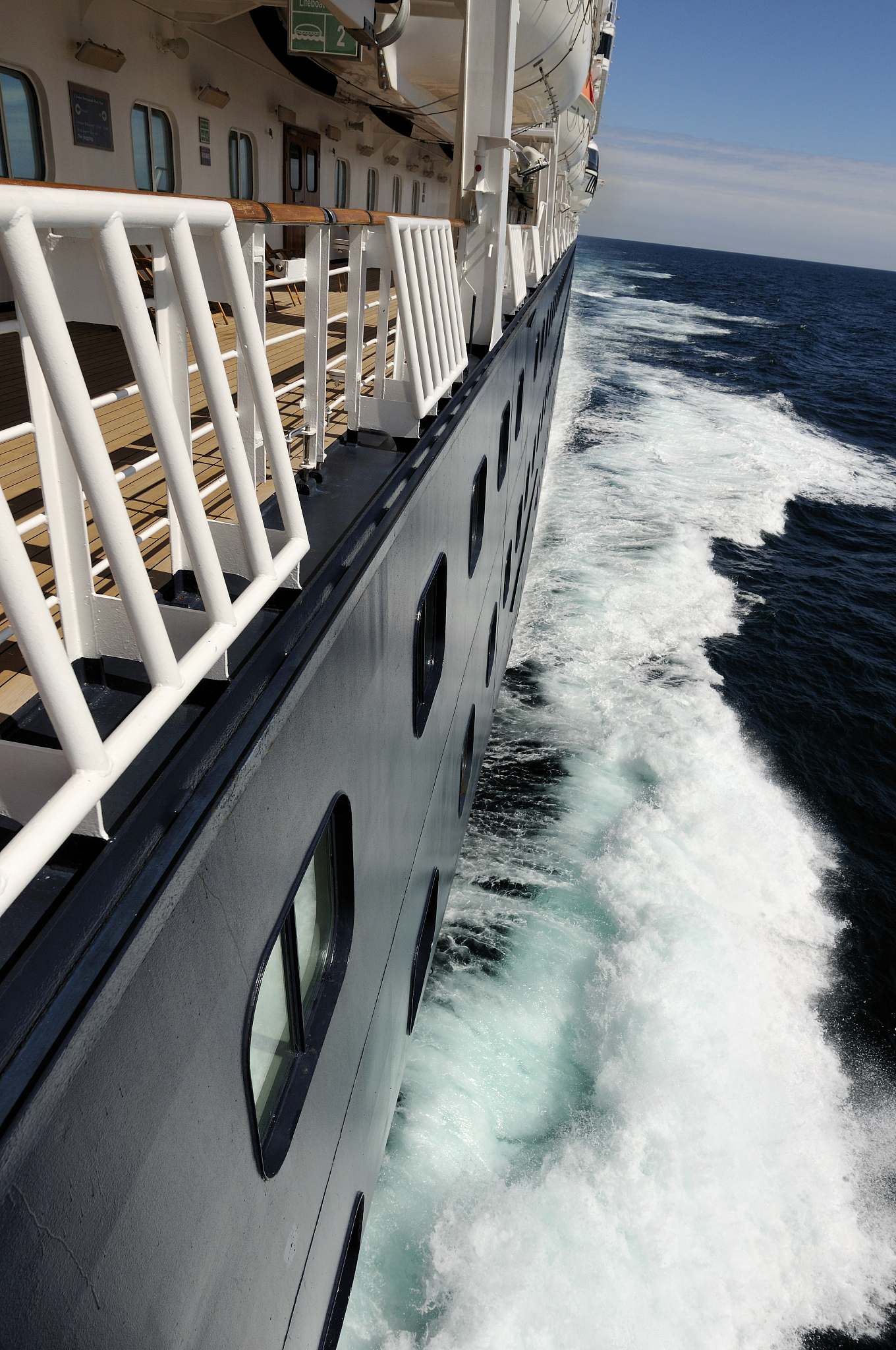 over the rail view of a ship and waves.