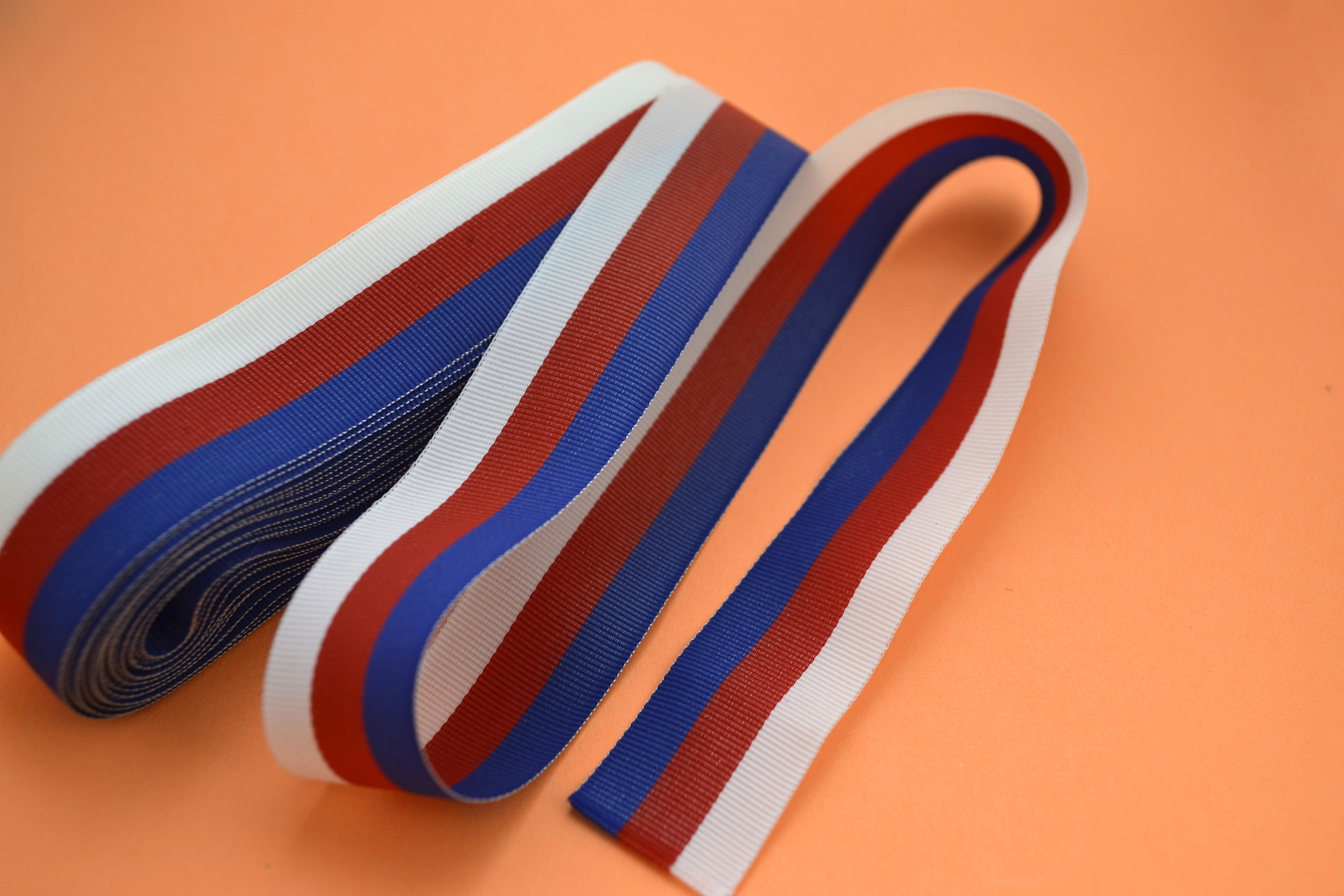 roll of ribbons on an orange background