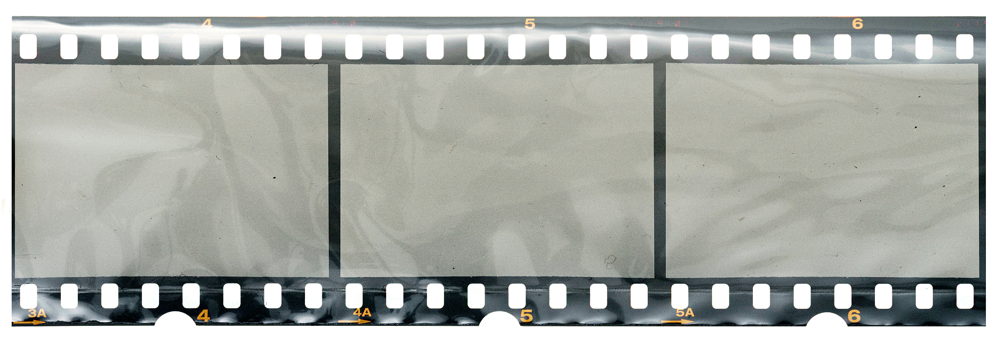 long 35mm film or movie strip in foil with empty frames or cells