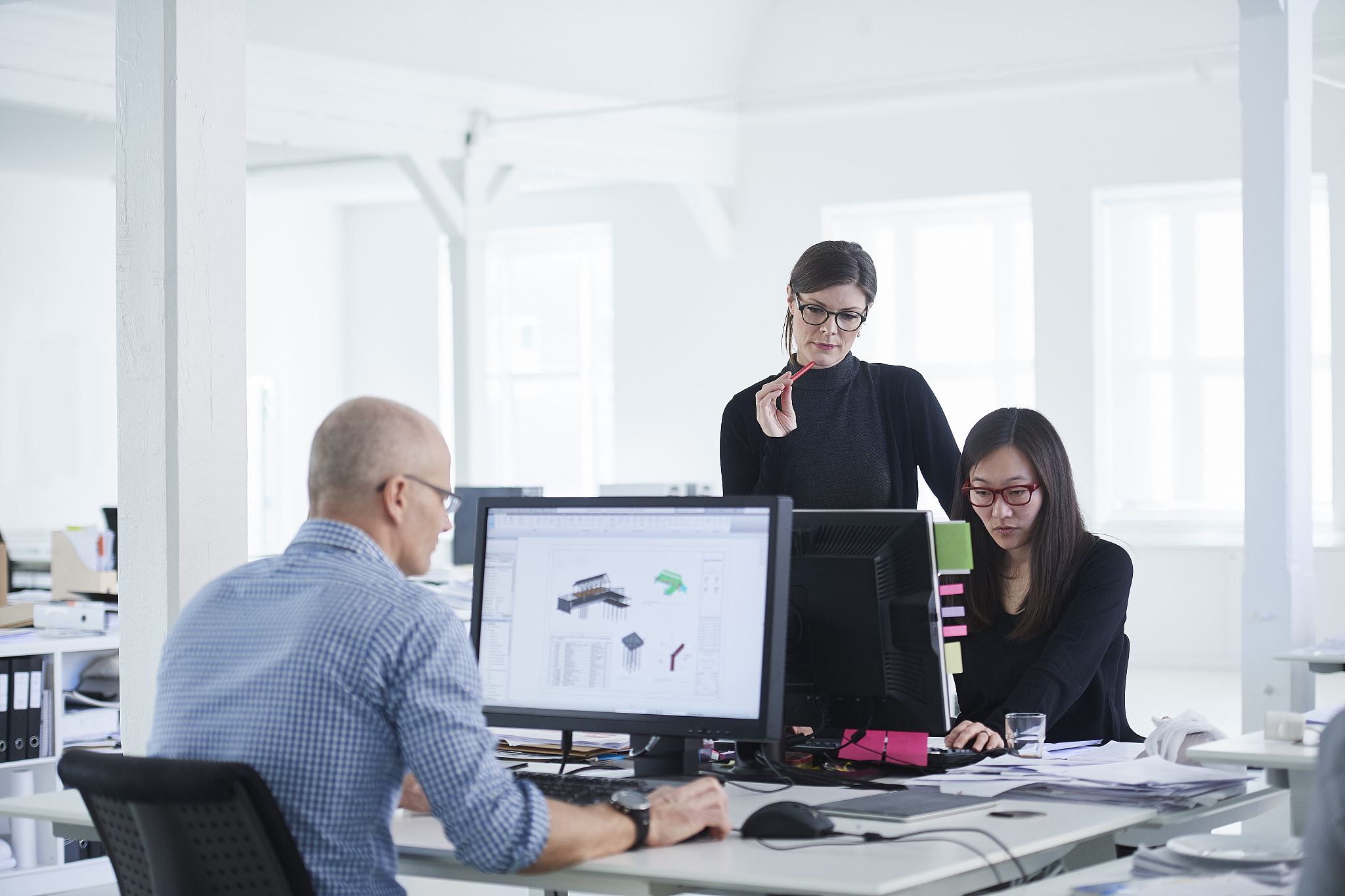 colleagues working in office, using computer