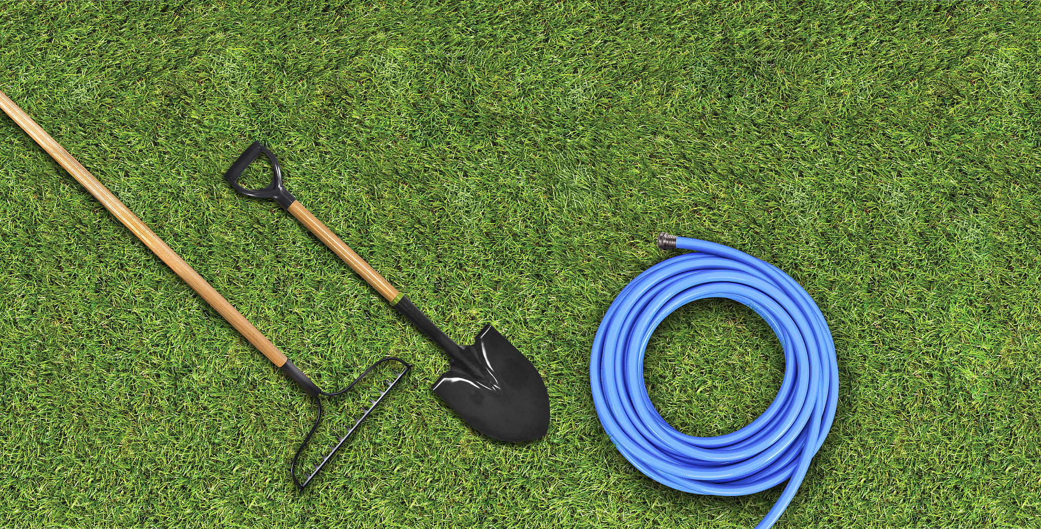 gardening tools, hose, shovel & rake on a grass