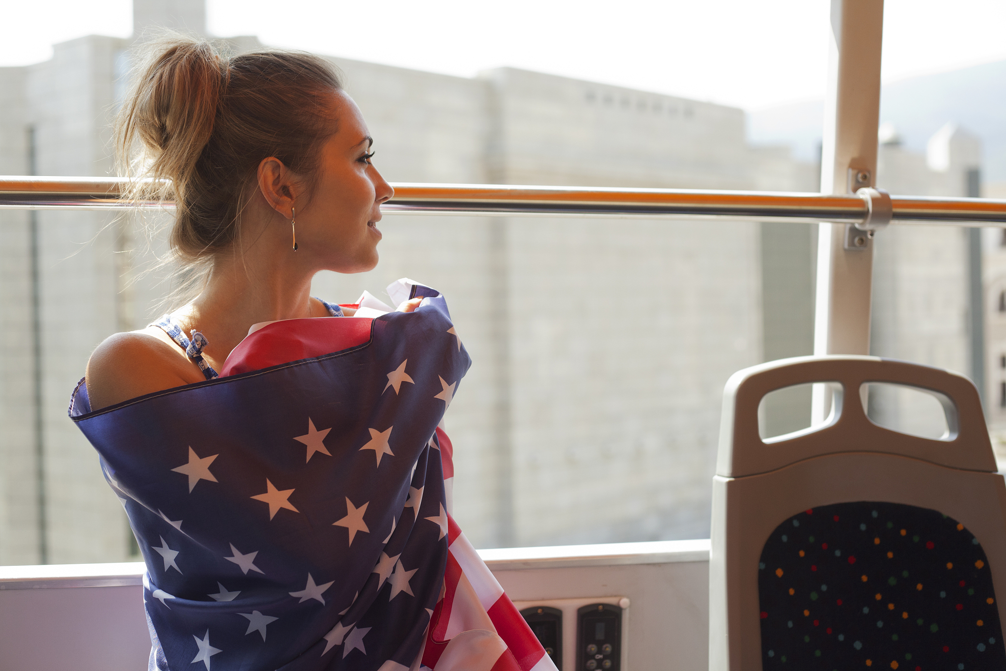 young woman holding flag of usa