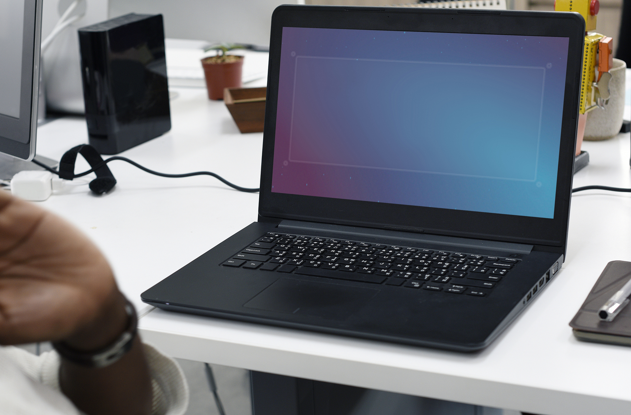man working in an office with his laptop