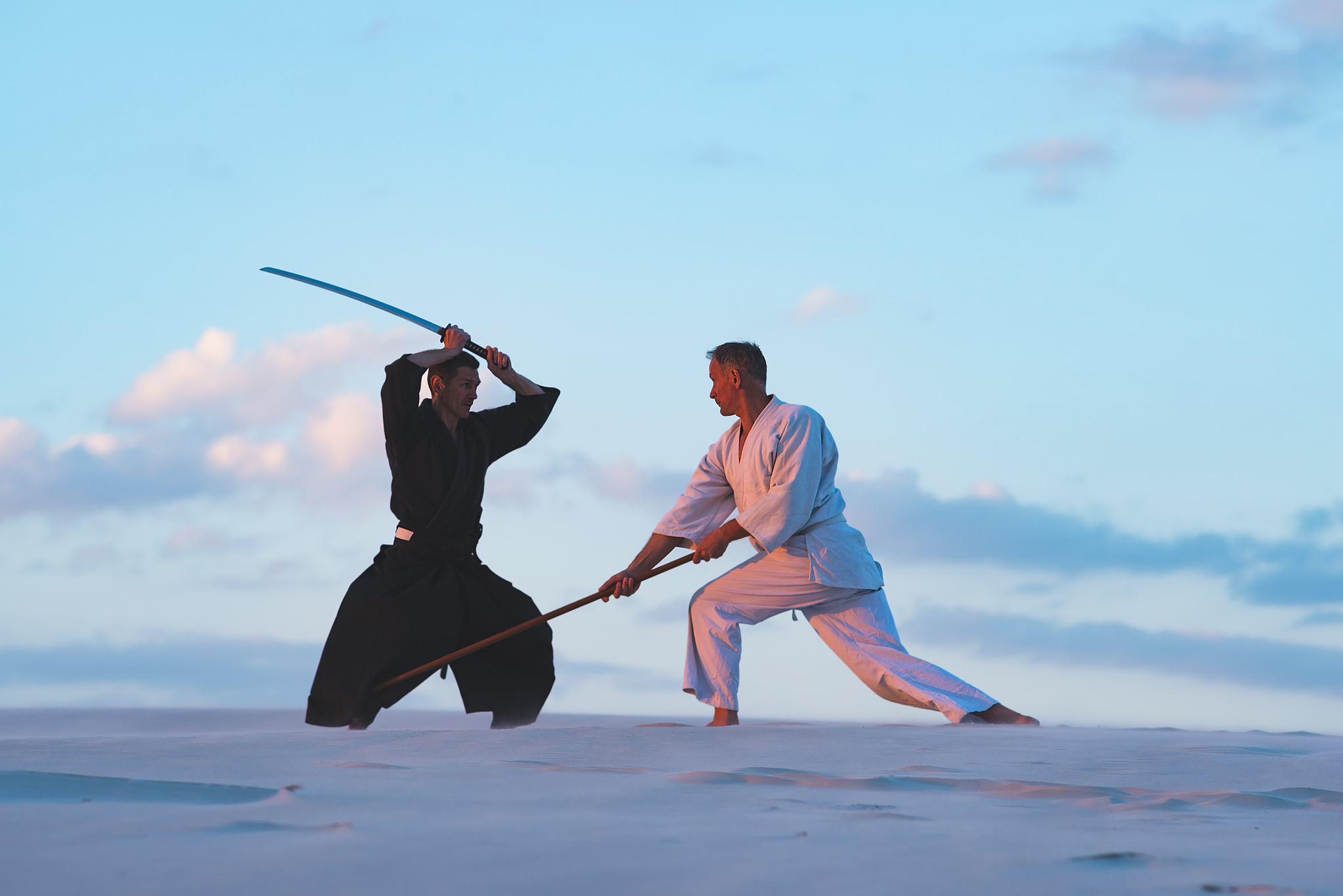 concentrated men, in japanese clothes, are practicing martial ar