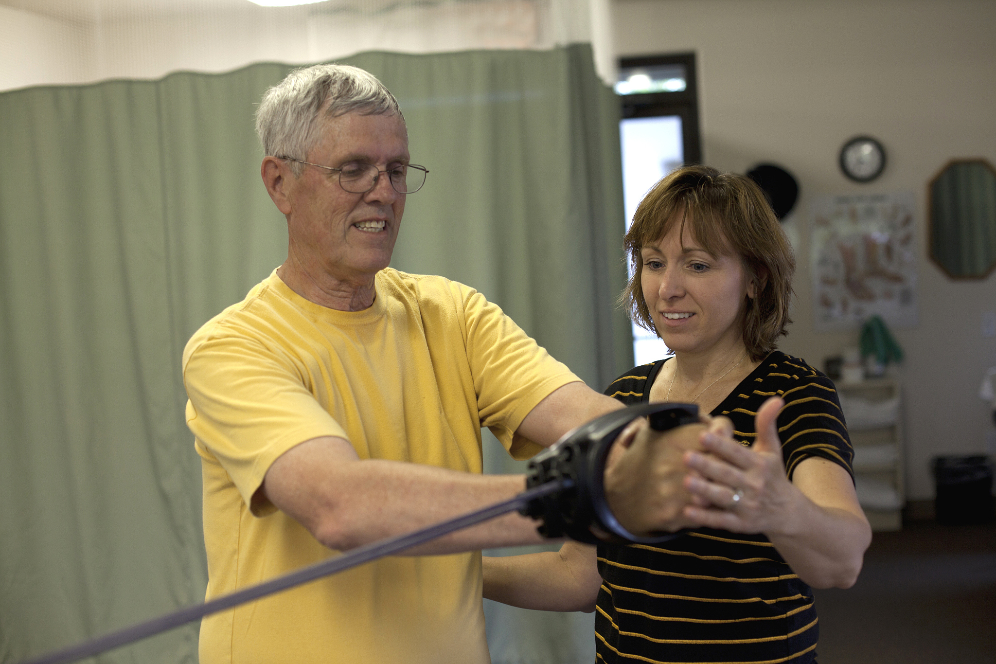 physical therapist working with patient at clinic.