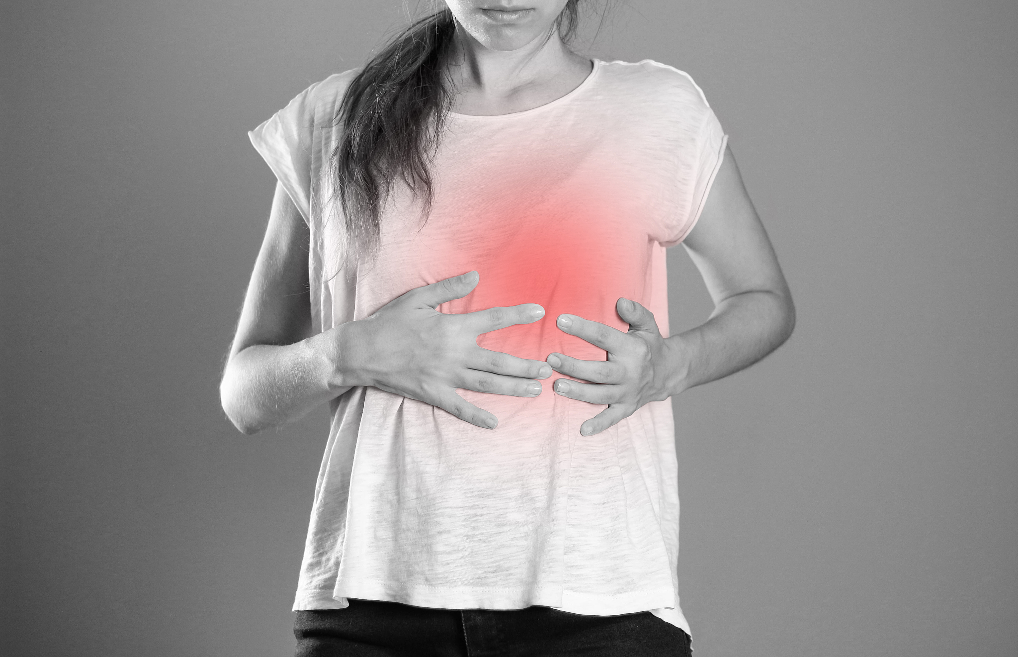 the girl is holding her heart. pain in heart. close up. isolated
