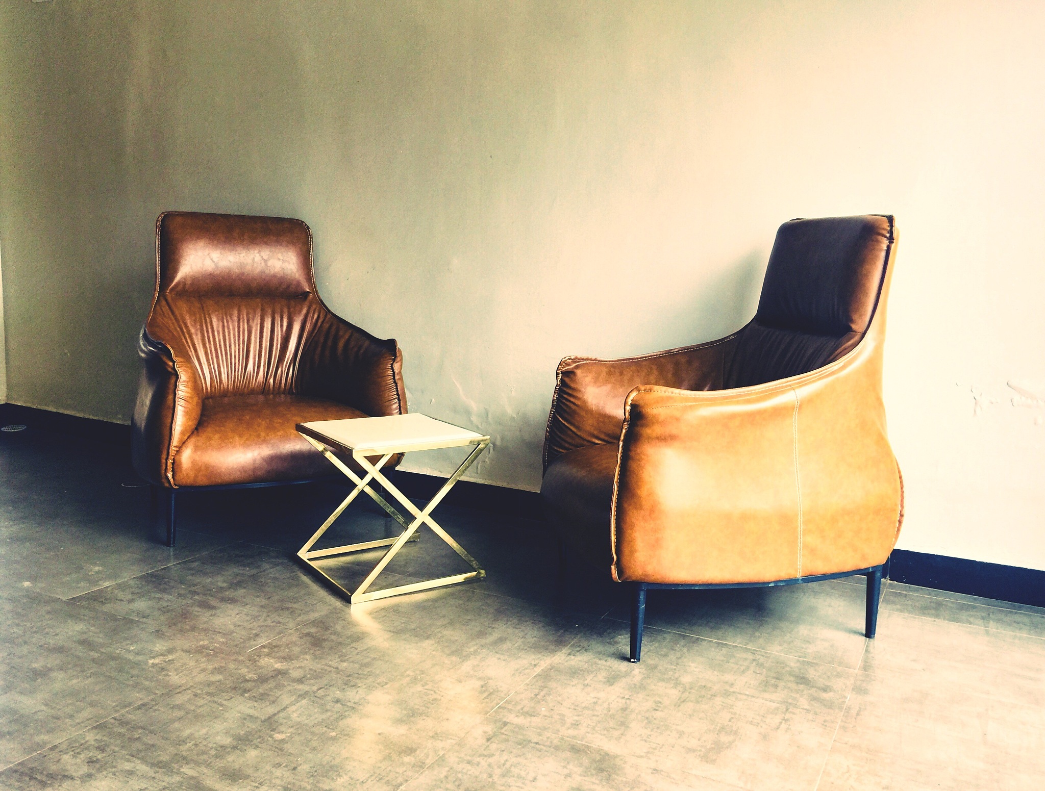 empty chairs and table on floor against wall at home