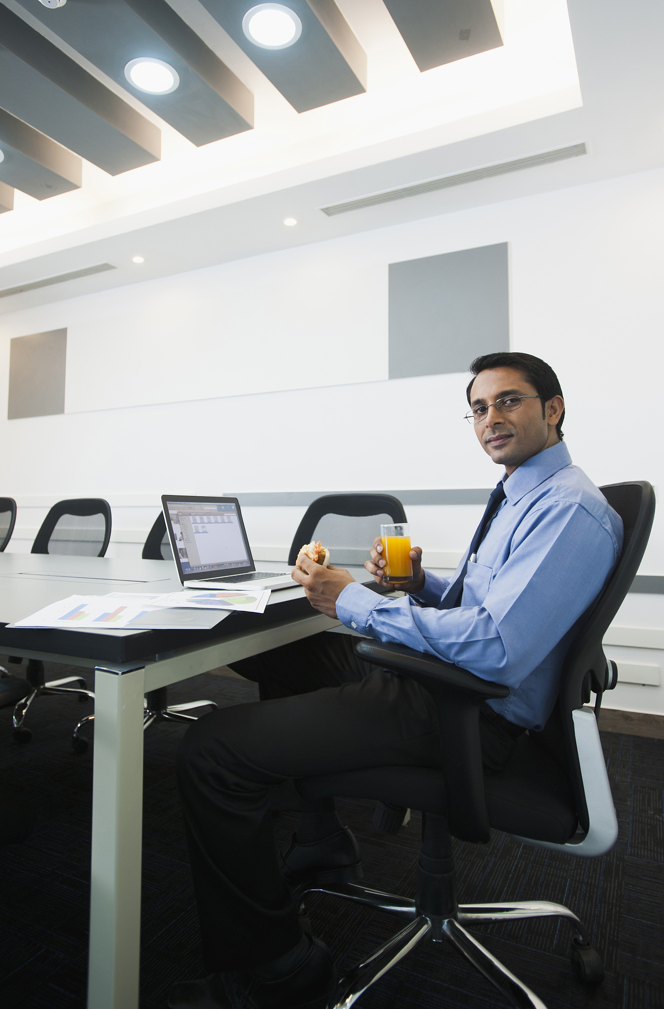 businessman sitting in office and having food