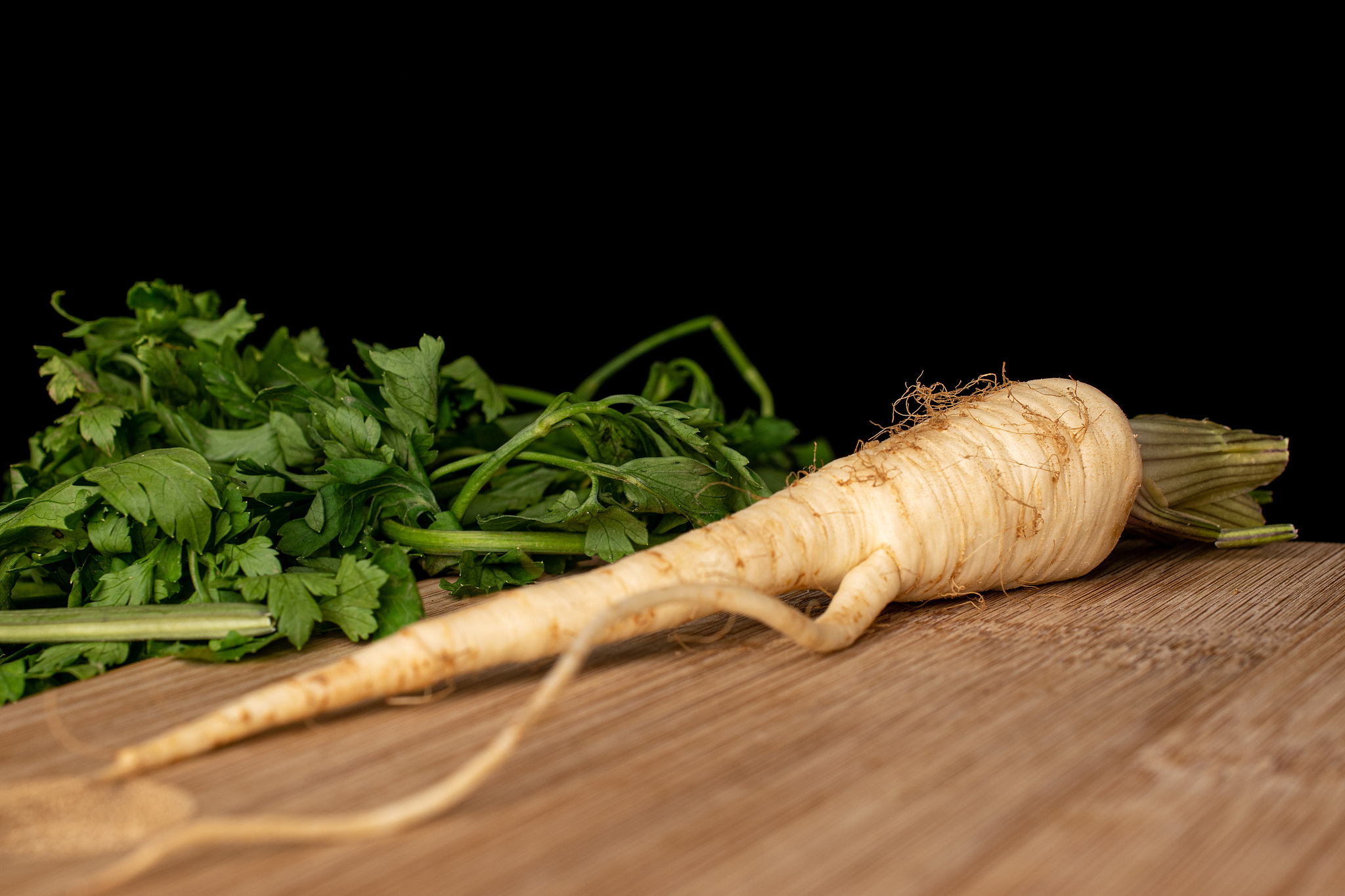 white parsley root isolated on black glass