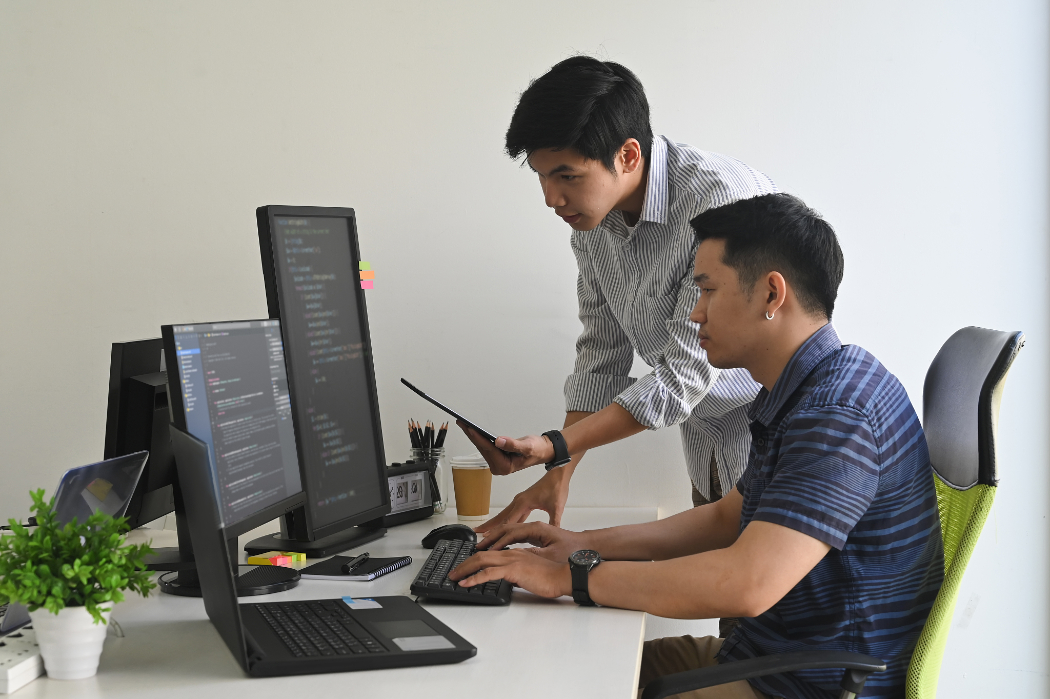 young programmers working on computer and tablet in modern offic