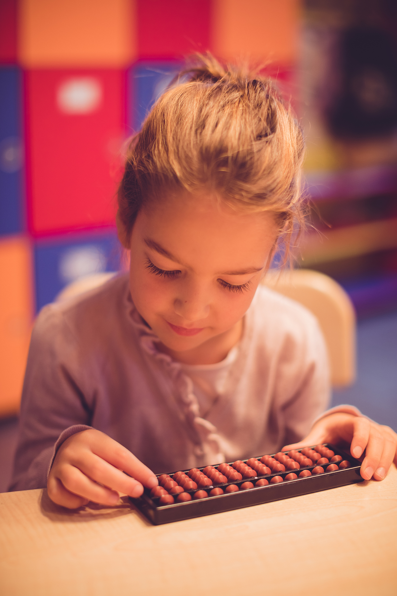 schoolgirl using abacus to calculate