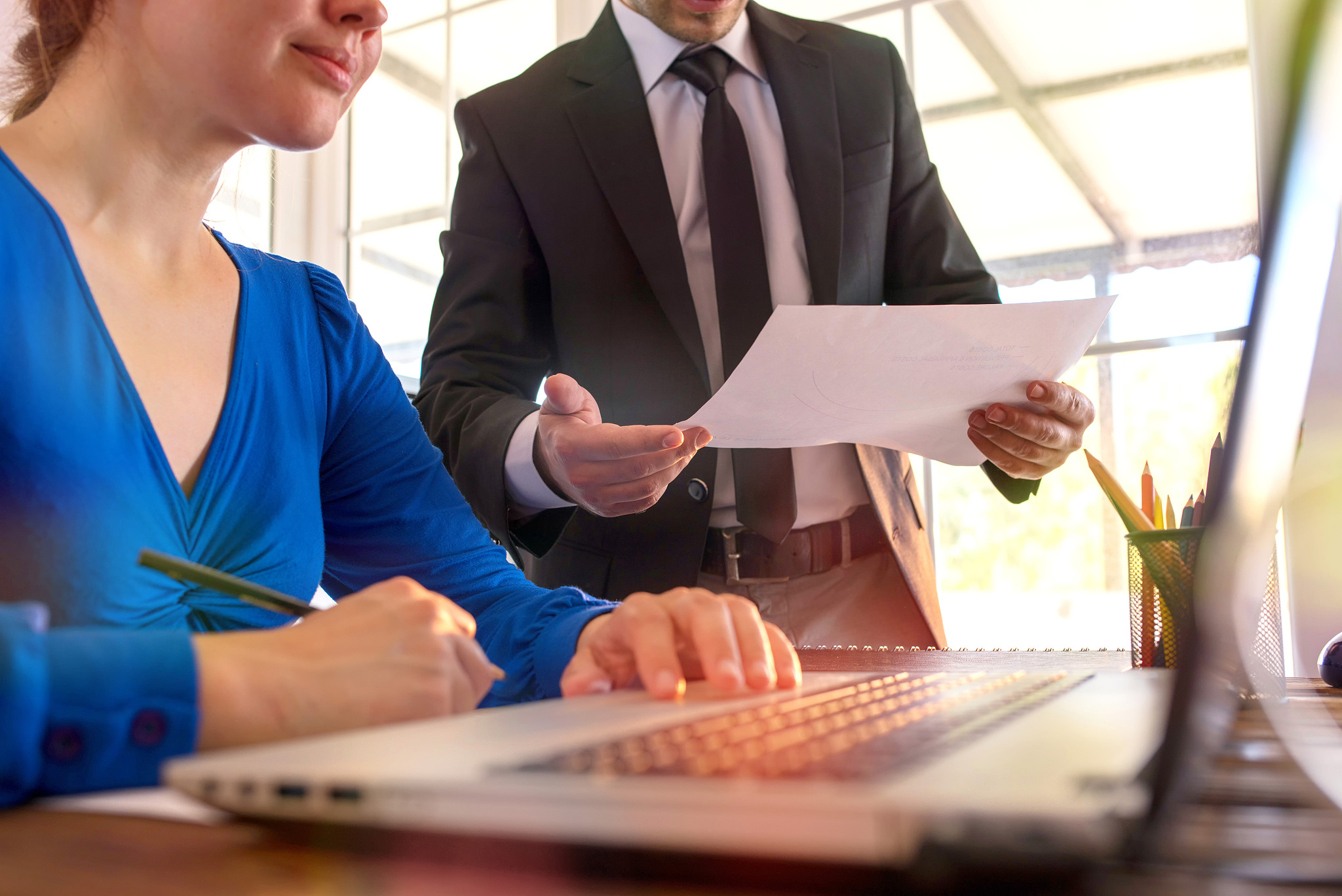 businessman and businesswoman working in office together in coop