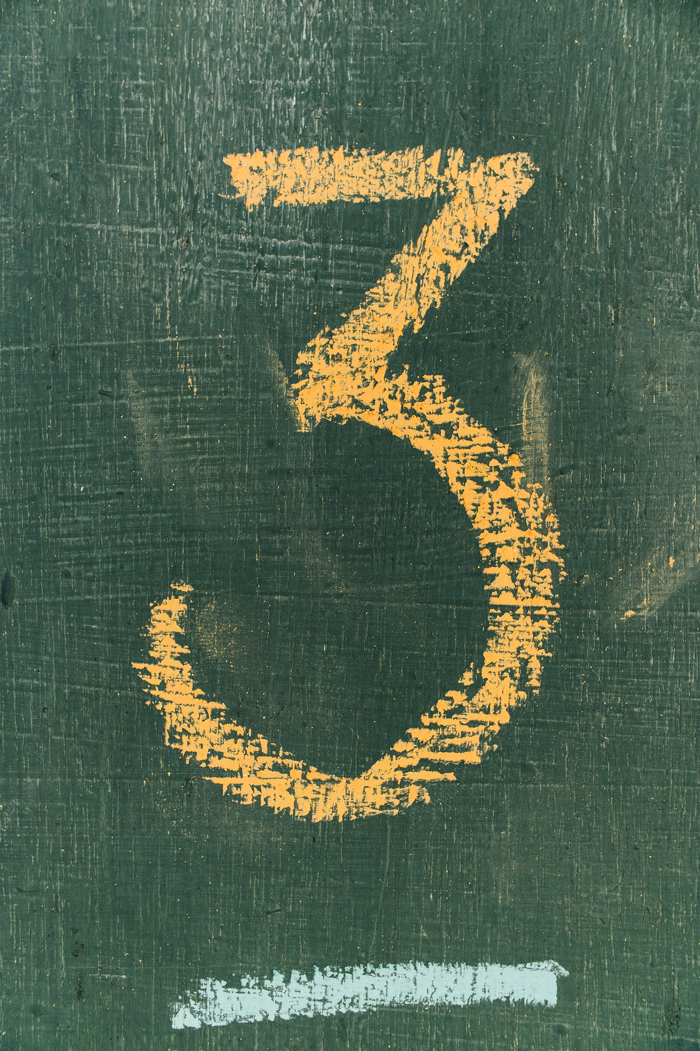 number three written hand chalk on board.text number three on ch