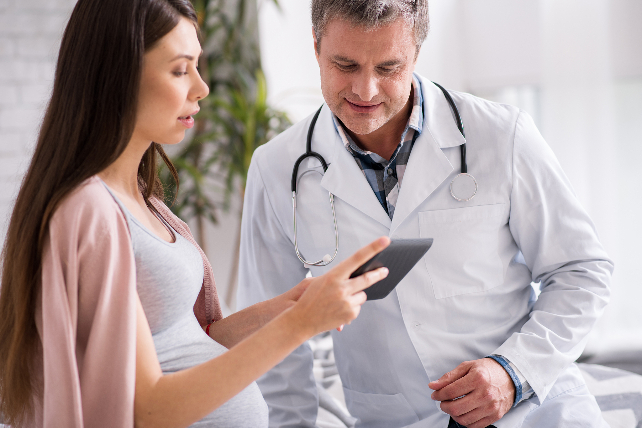 attentive woman showing pictures to her doc
