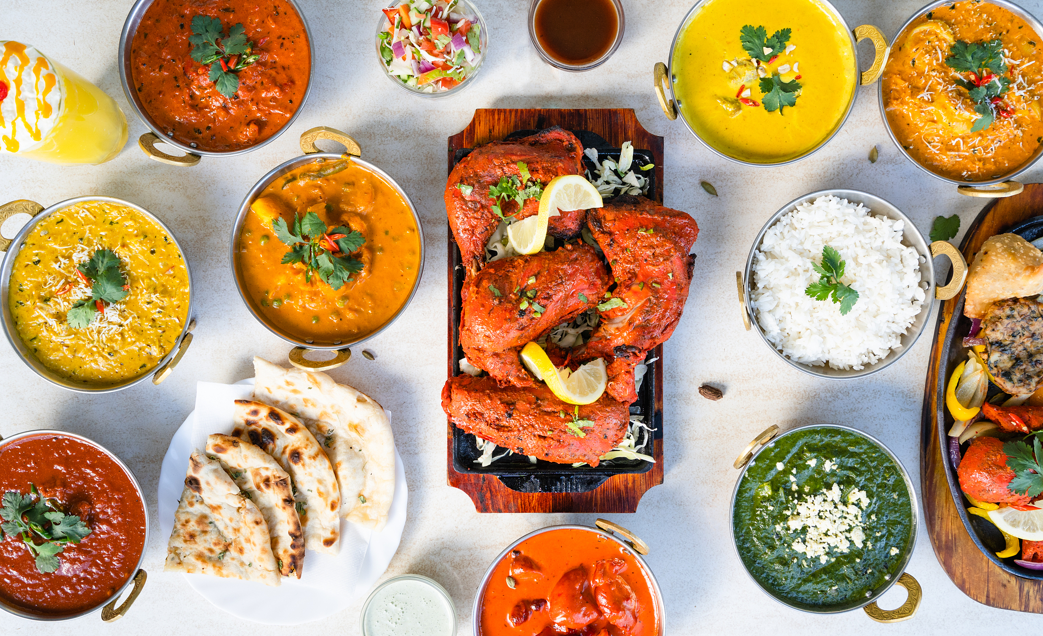 table full of indian food.