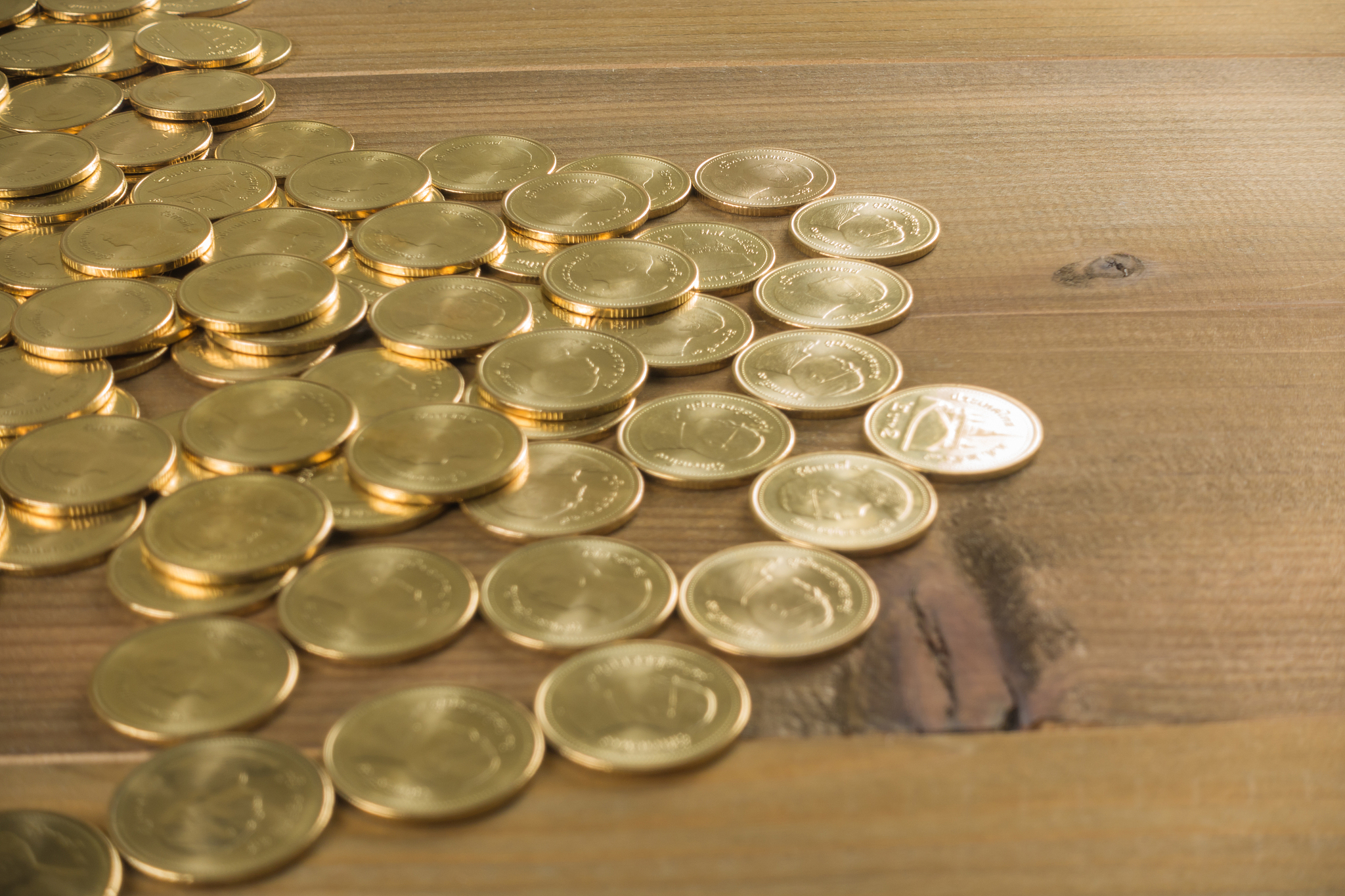 gold coins. on wooden background.