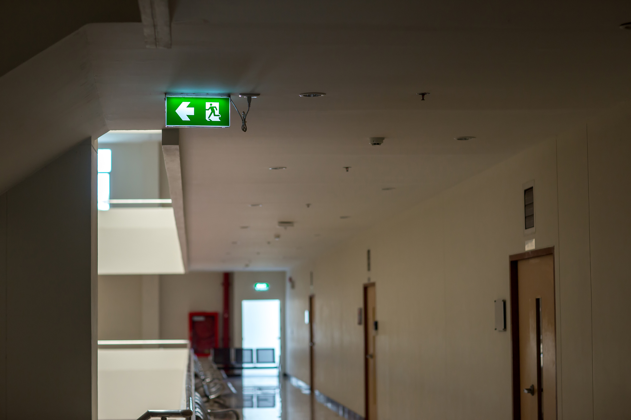 green emergency exit sign showing the way to escape.fire exit in