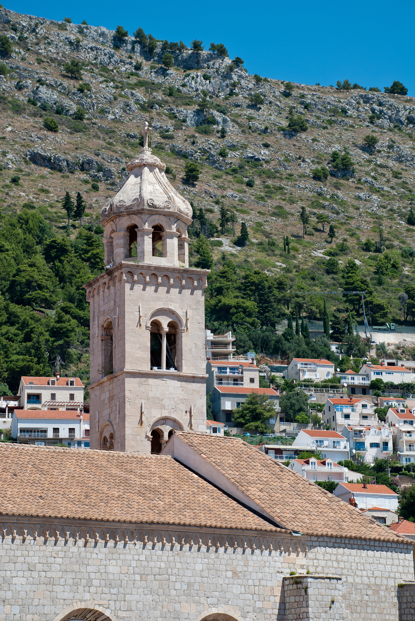 view of dominican monastery in dubrovnik with slim tower inside 