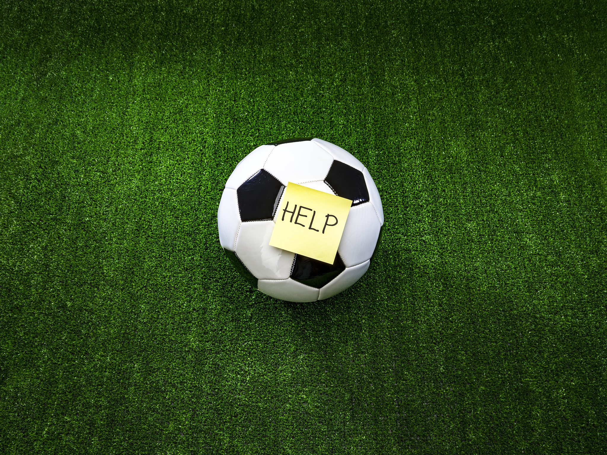 soccer ball with help inscription