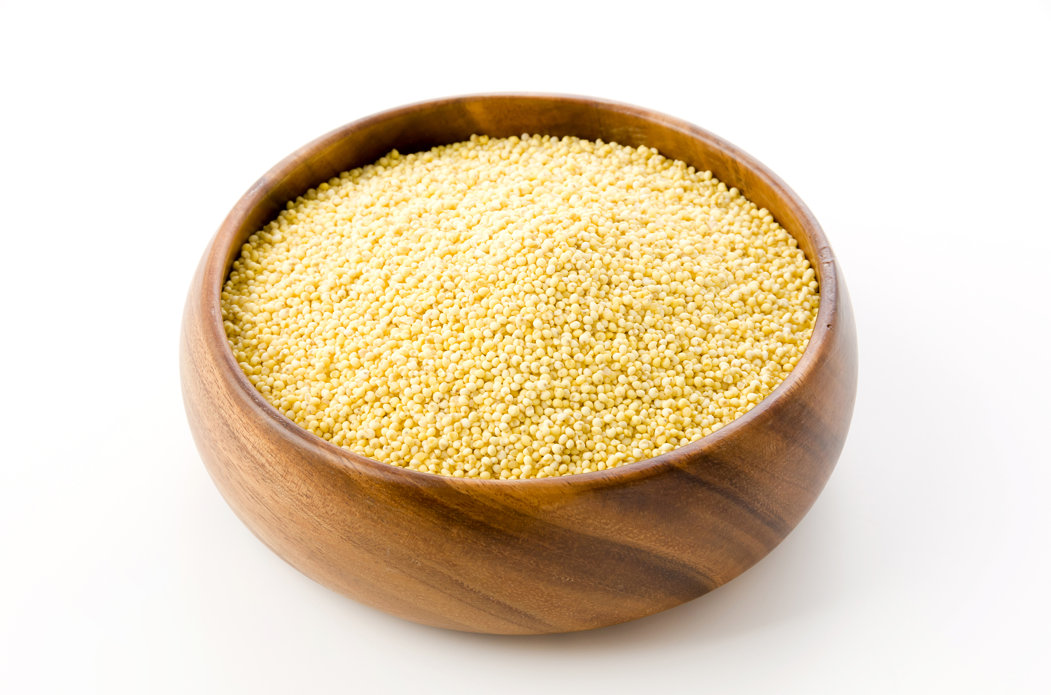 glutinous millet in round wooden bowl on white background