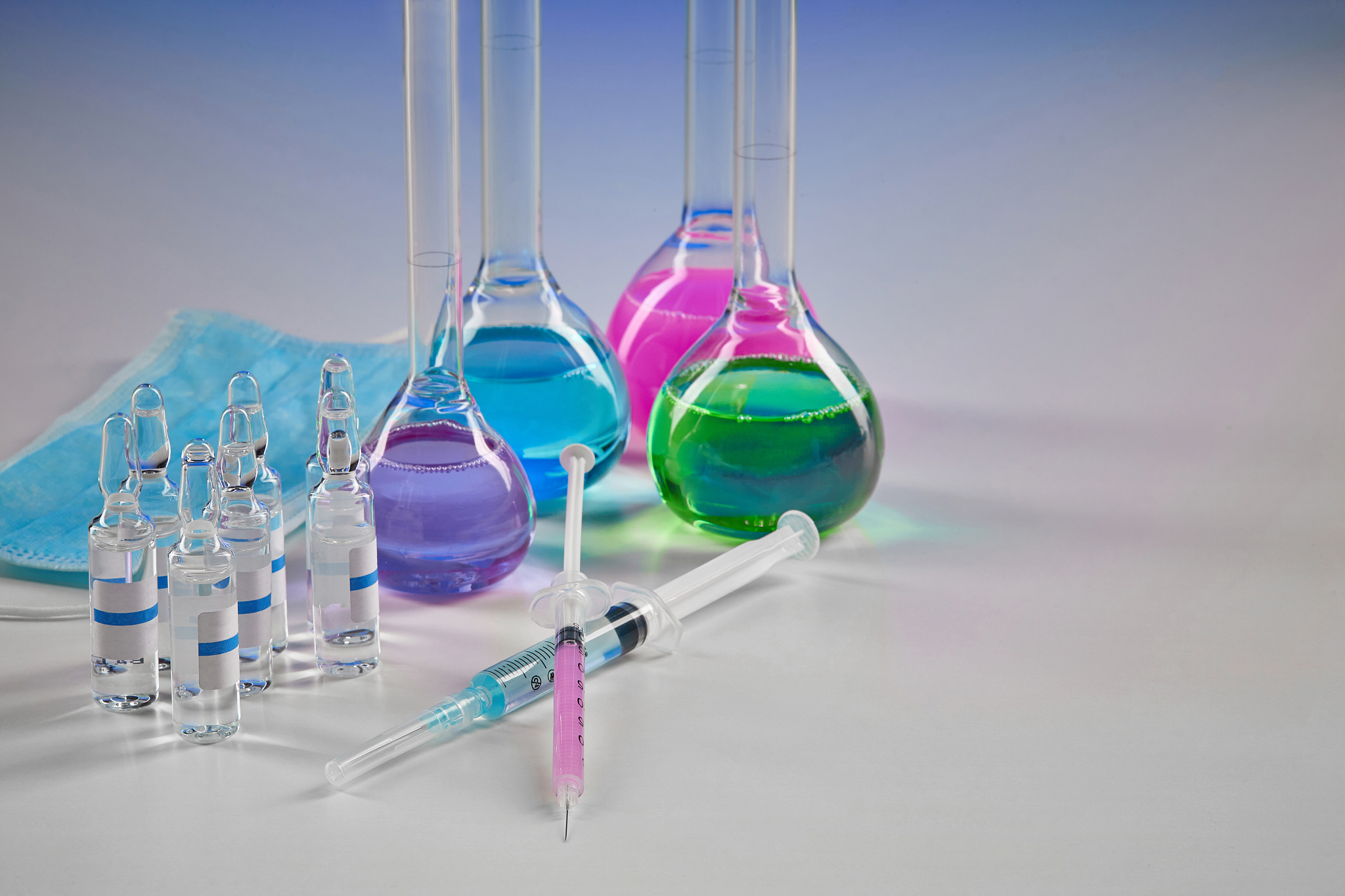 four medical flasks with colorful chemical reagents. seven mocku