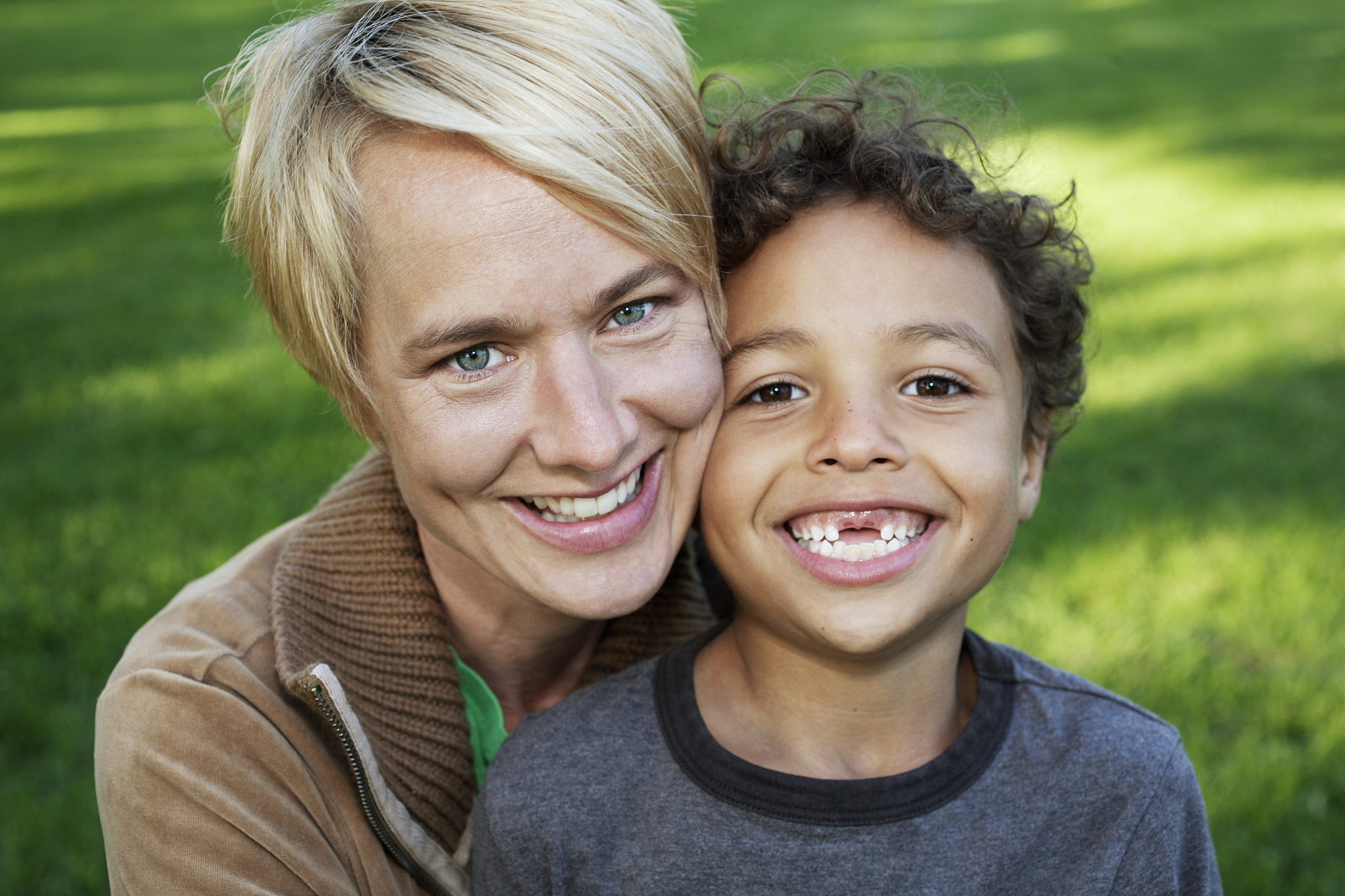 portrait of mother and son (7-9) embracing