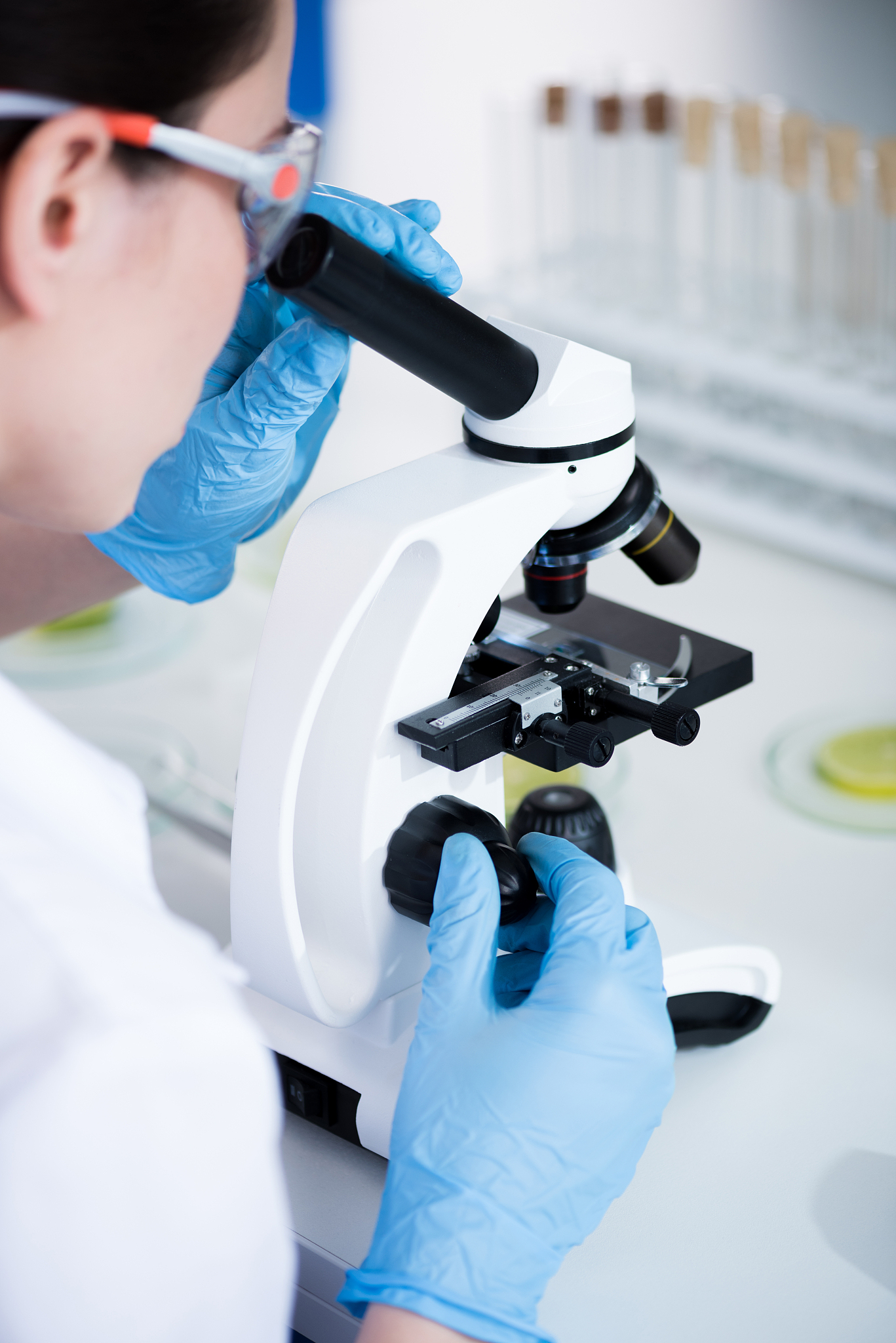 female scientist during work with microscope at modern biologica