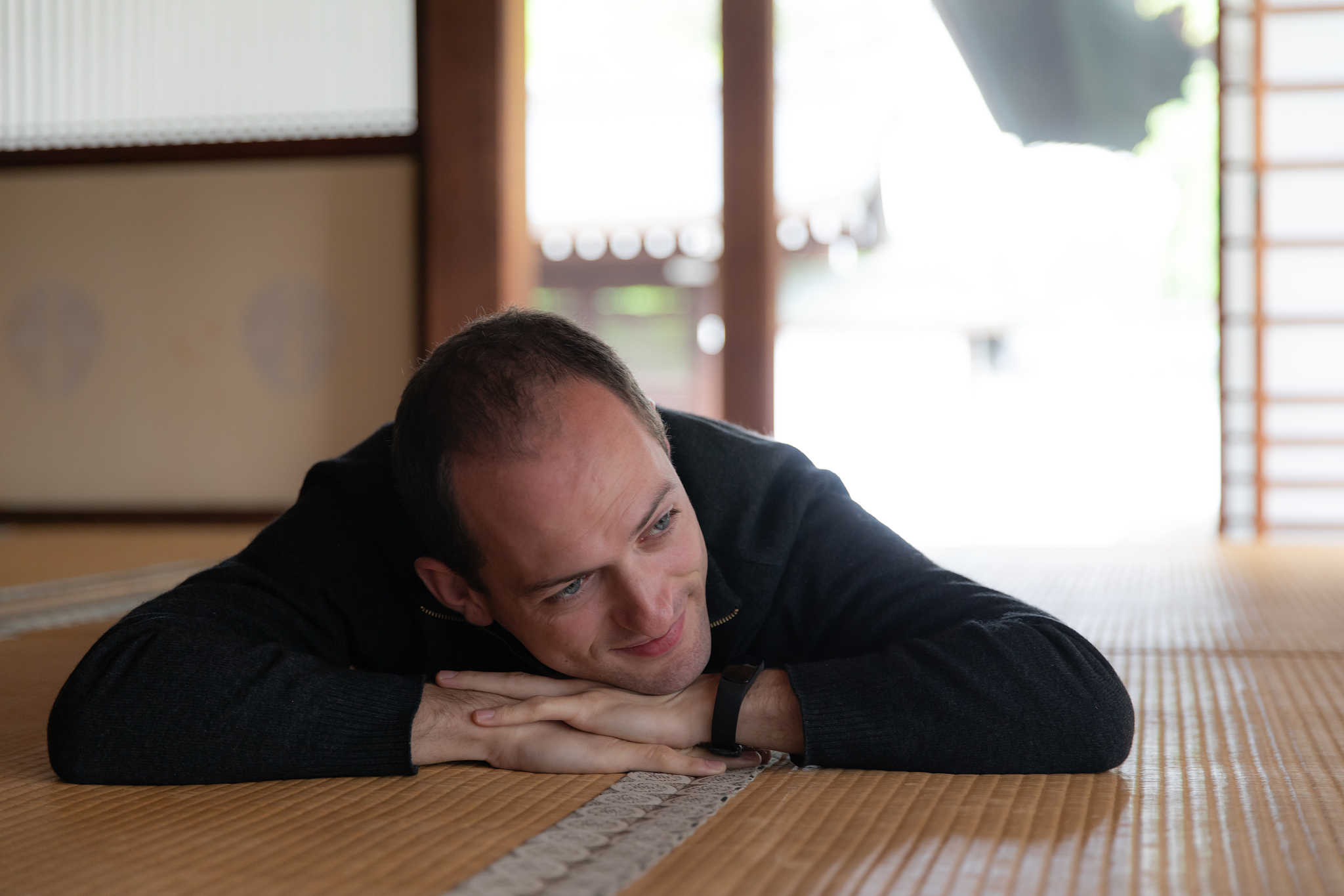 caucasian man lying down in japanese room