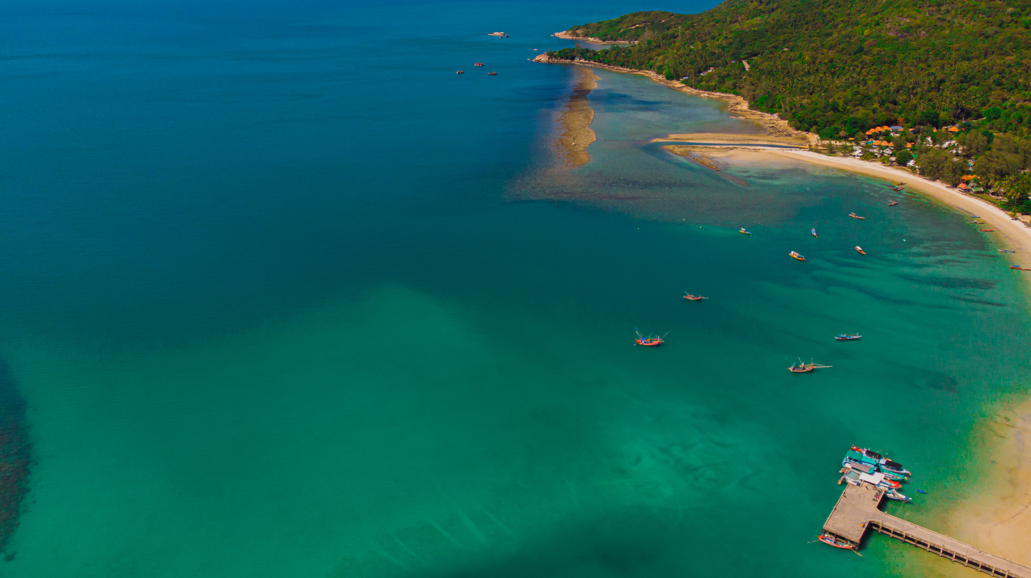 aerial drone point of view of moored boats, ocean water surface