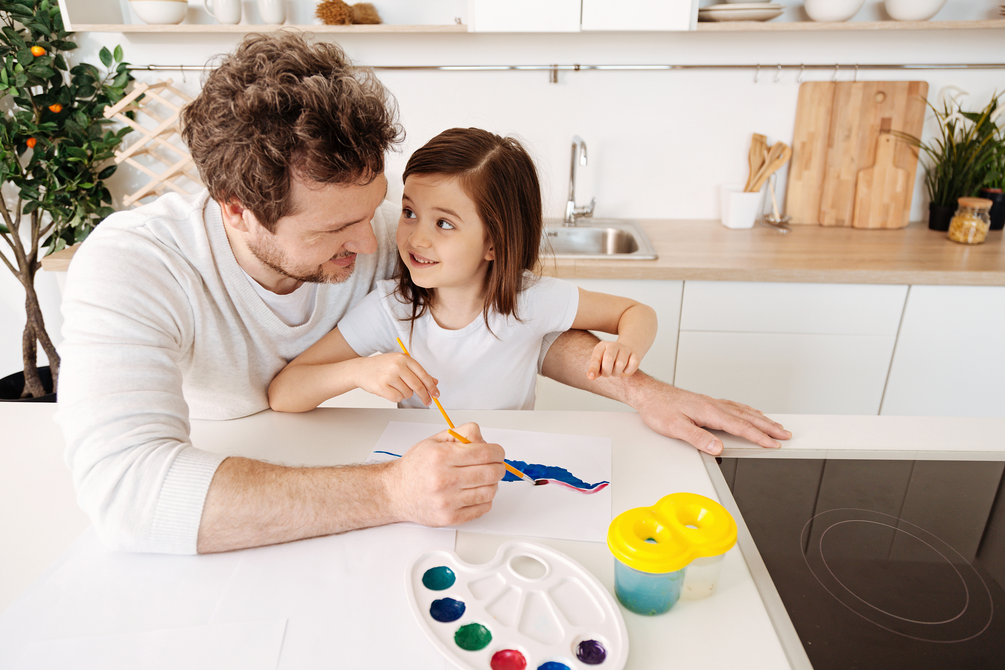 happy father painting together with his daughter