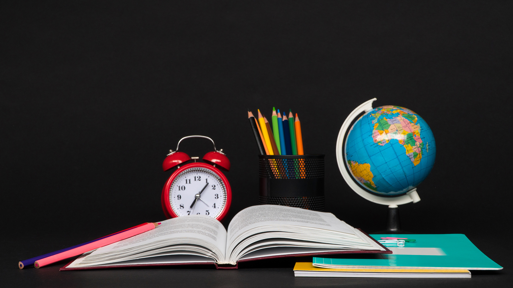 school supplies on black background