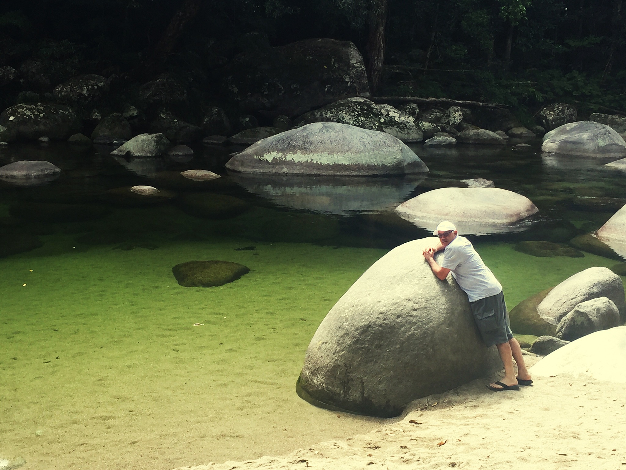 portrait of man standing by rocks at shore